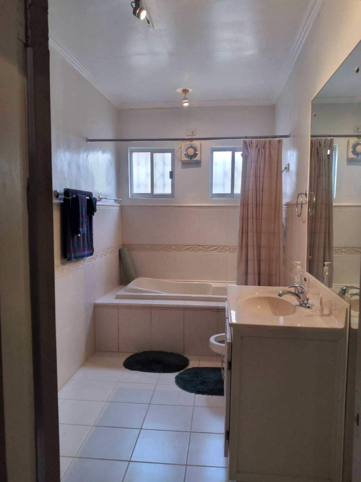 Bathroom in guest house with bathtub, sink, and toilet