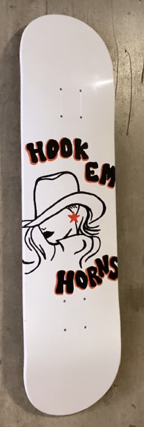 A skateboard deck with a graphic of a woman wearing a cowboy hat and a star-shaped eye, surrounded by the text "HOOK EM HORNS" in black and red letters.