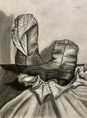 A detailed black and white drawing of a pair of worn sneakers with laces, resting on a piece of cloth or sock, with a textured background.