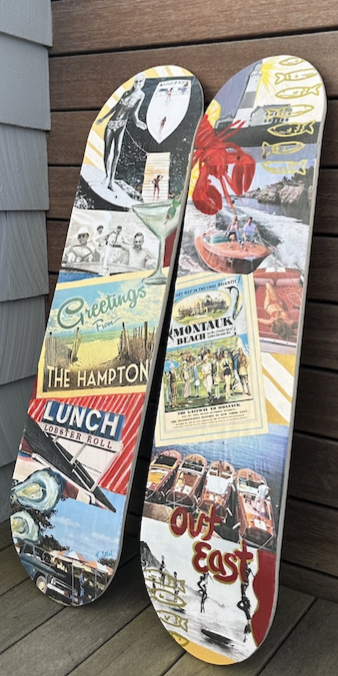 Two skateboards with colorful, vintage travel-themed graphics leaning against a wooden wall.