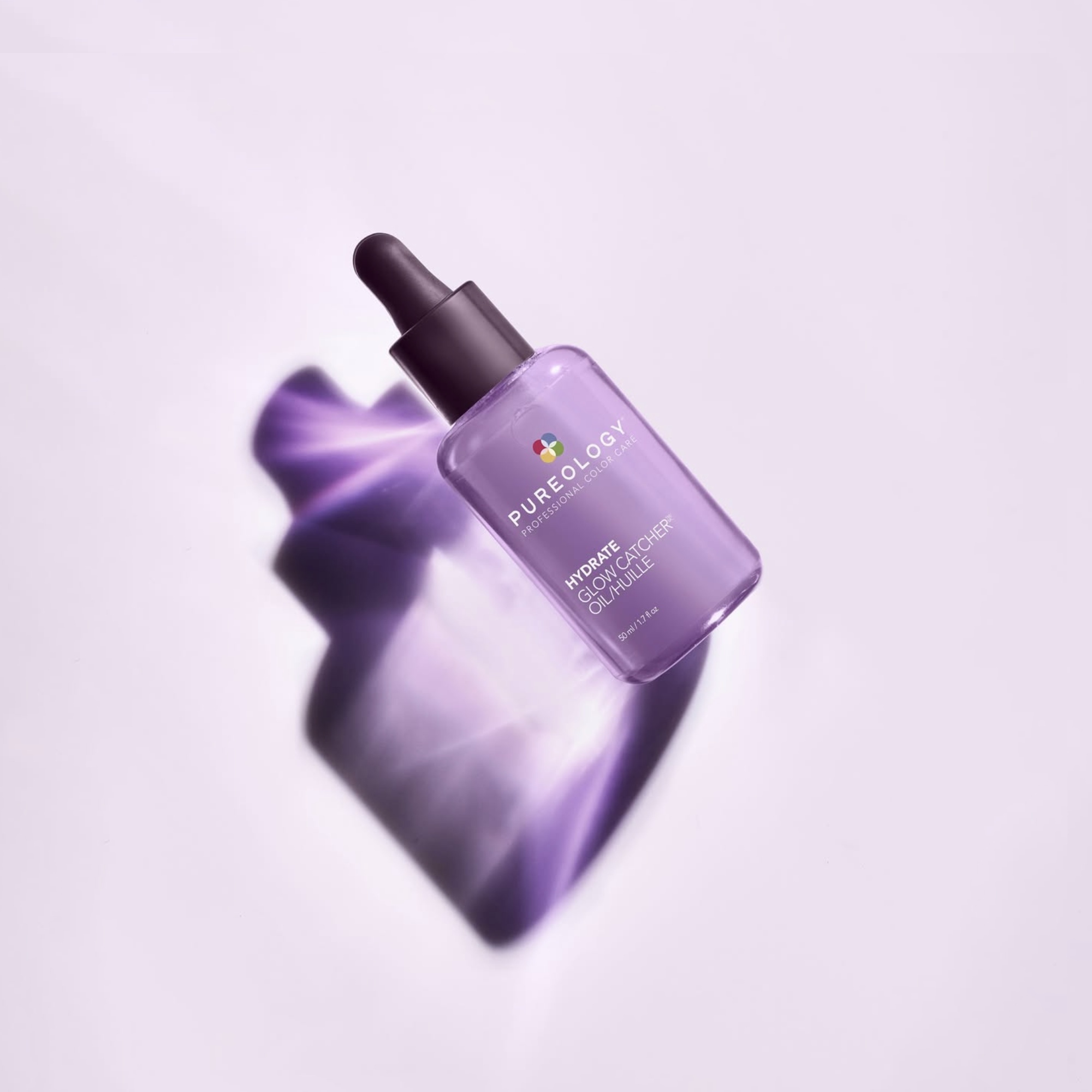 A purple bottle of Pureology Hydrate Glow Catcher oil with a dropper cap, casting a shadow on a white surface.