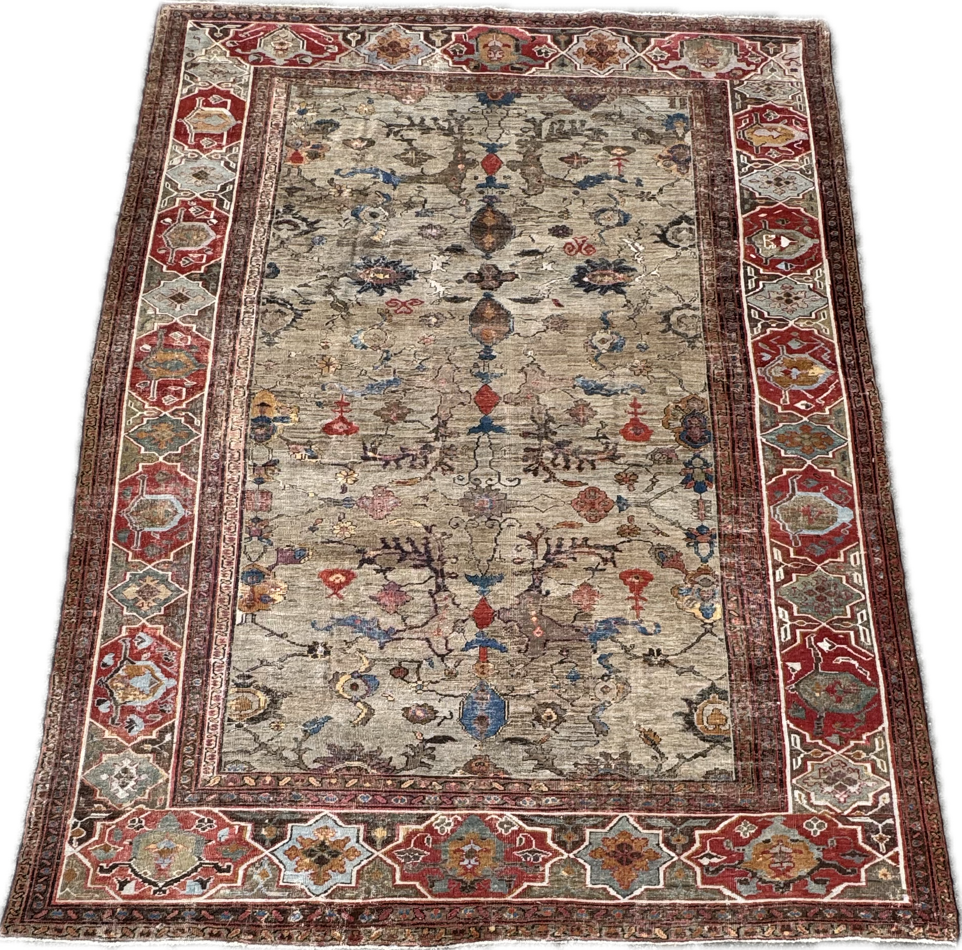 An ornate, traditional area rug with floral and geometric patterns in shades of red, beige, blue, and brown.