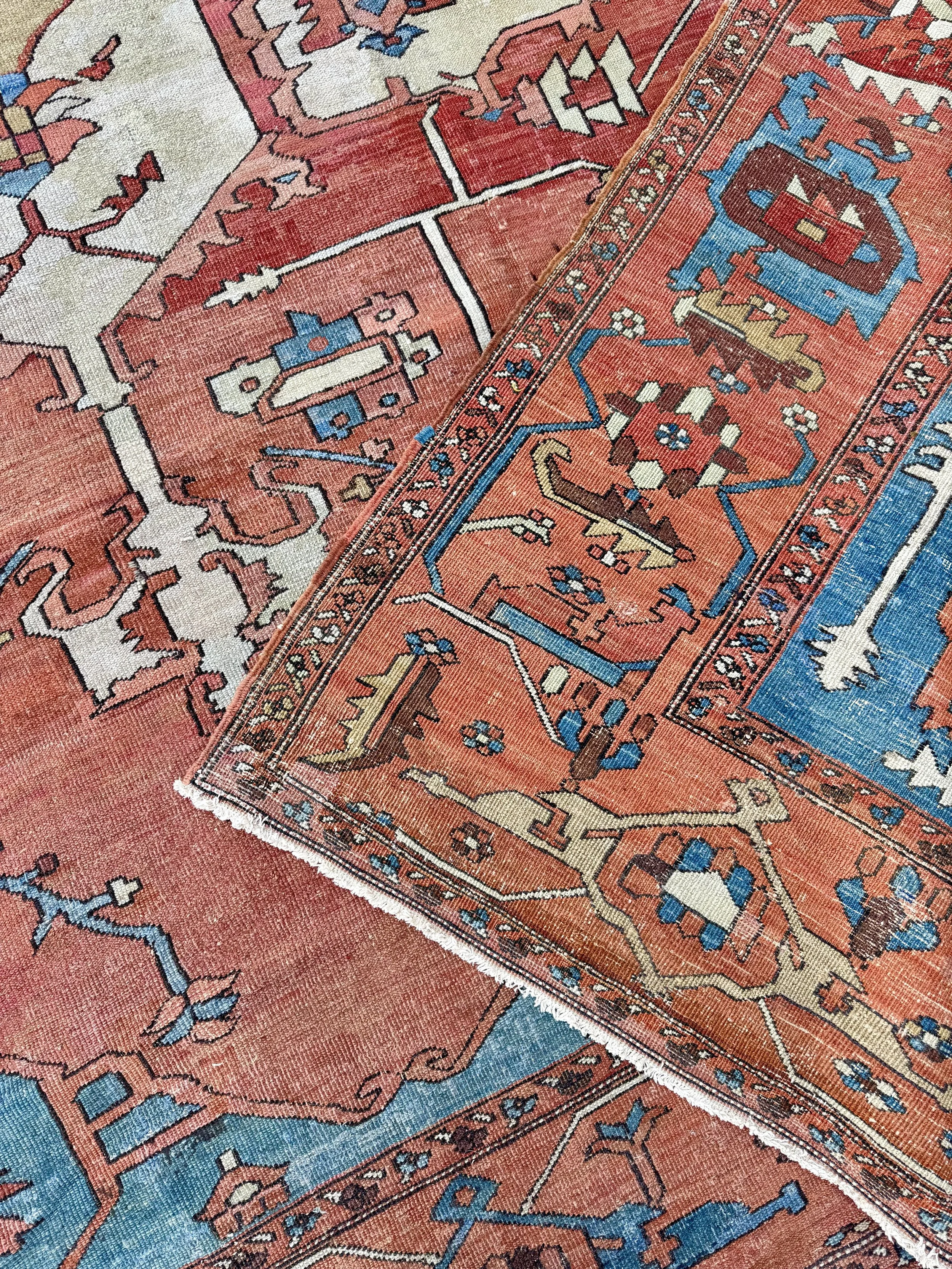 Close-up of a colorful traditional patterned rug with intricate geometric designs in red, blue, beige, and black.