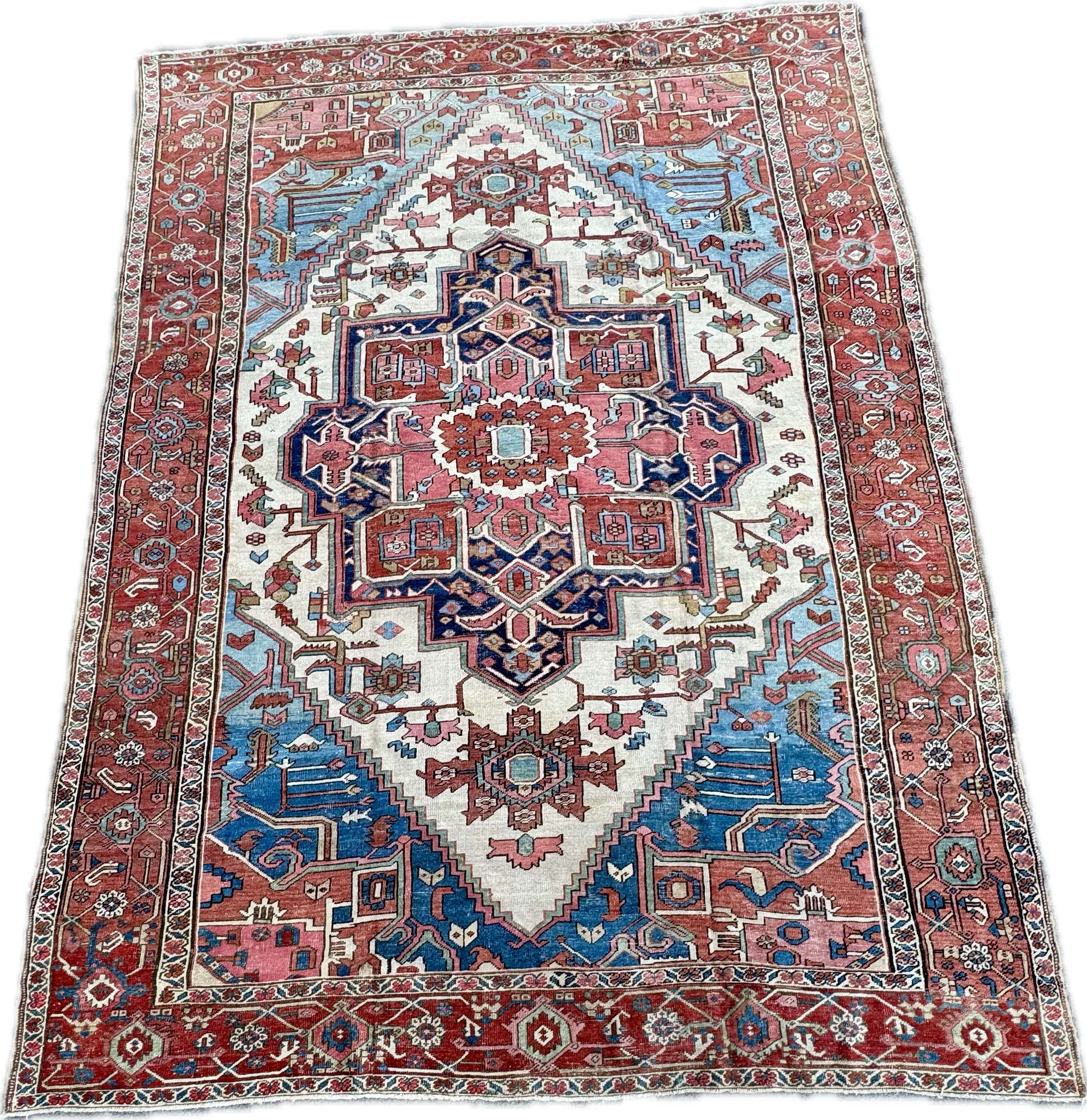 Colorful Persian-style area rug with red, blue, and cream geometric and floral patterns.