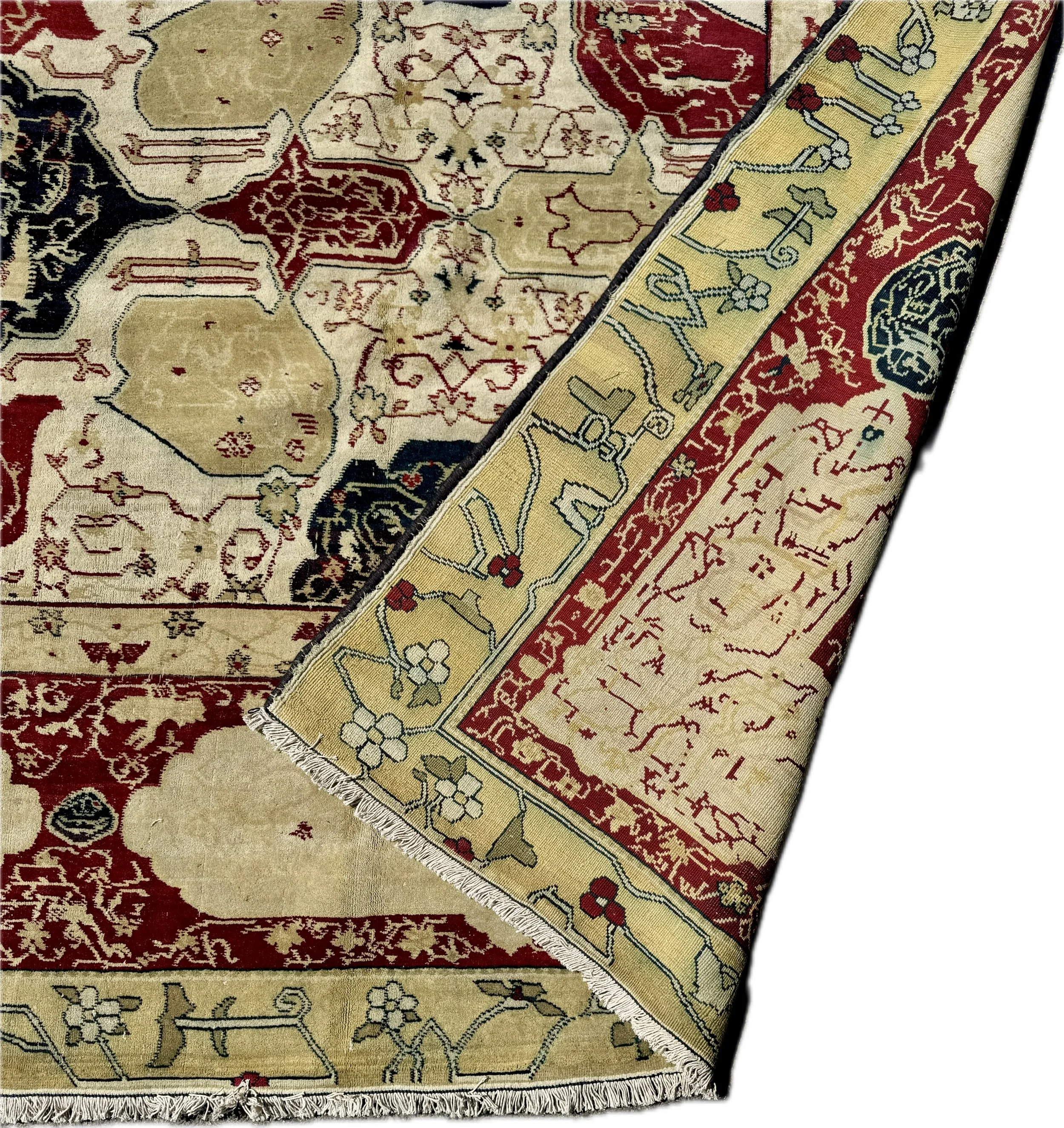 Close-up of a traditional Oriental rug with intricate floral and geometric patterns in red, beige, black, and yellow colors.