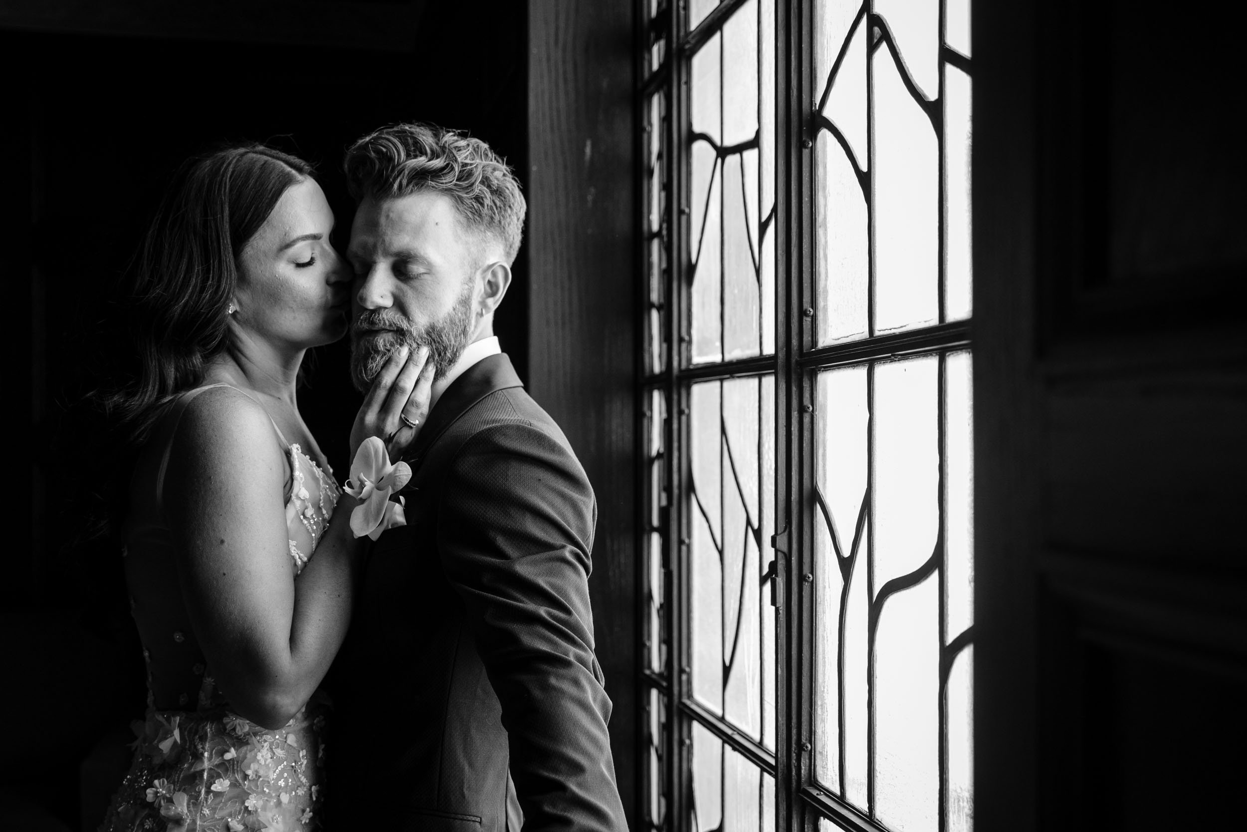 A private kiss in the corner at a Chicago Wedding.