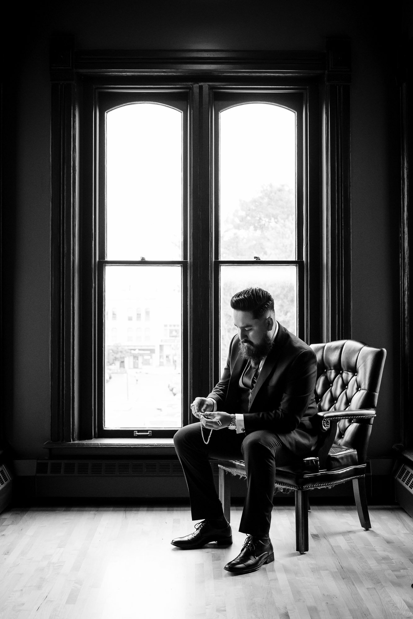 A groom prepares for his Wedding Day in Woodstock, IL, at the Square Courthouse.