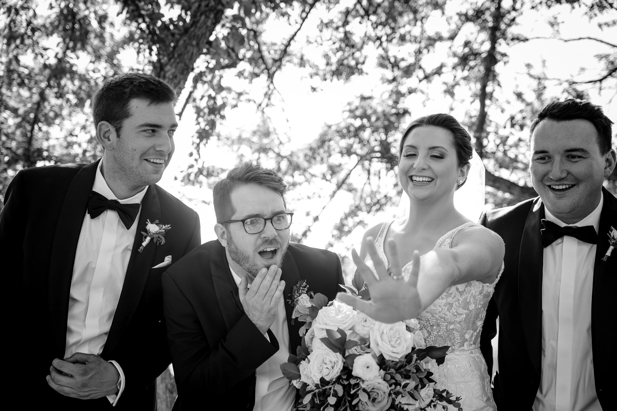 Groomsmen inspect the Brides Ring during portraits in Chicago, IL.