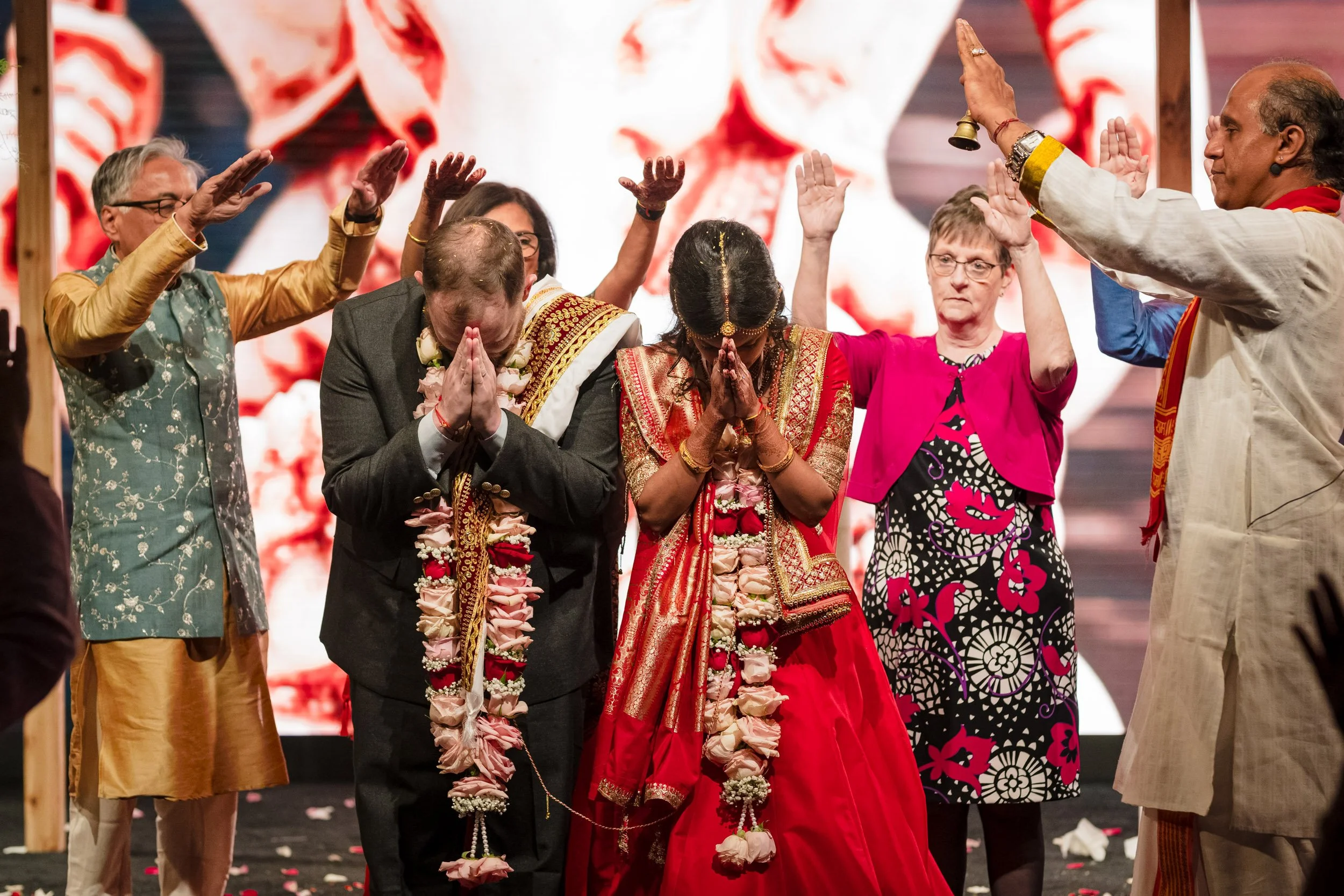 A family interacts with a couple during a Hindu Wedding Ceremony in Chicago, IL.