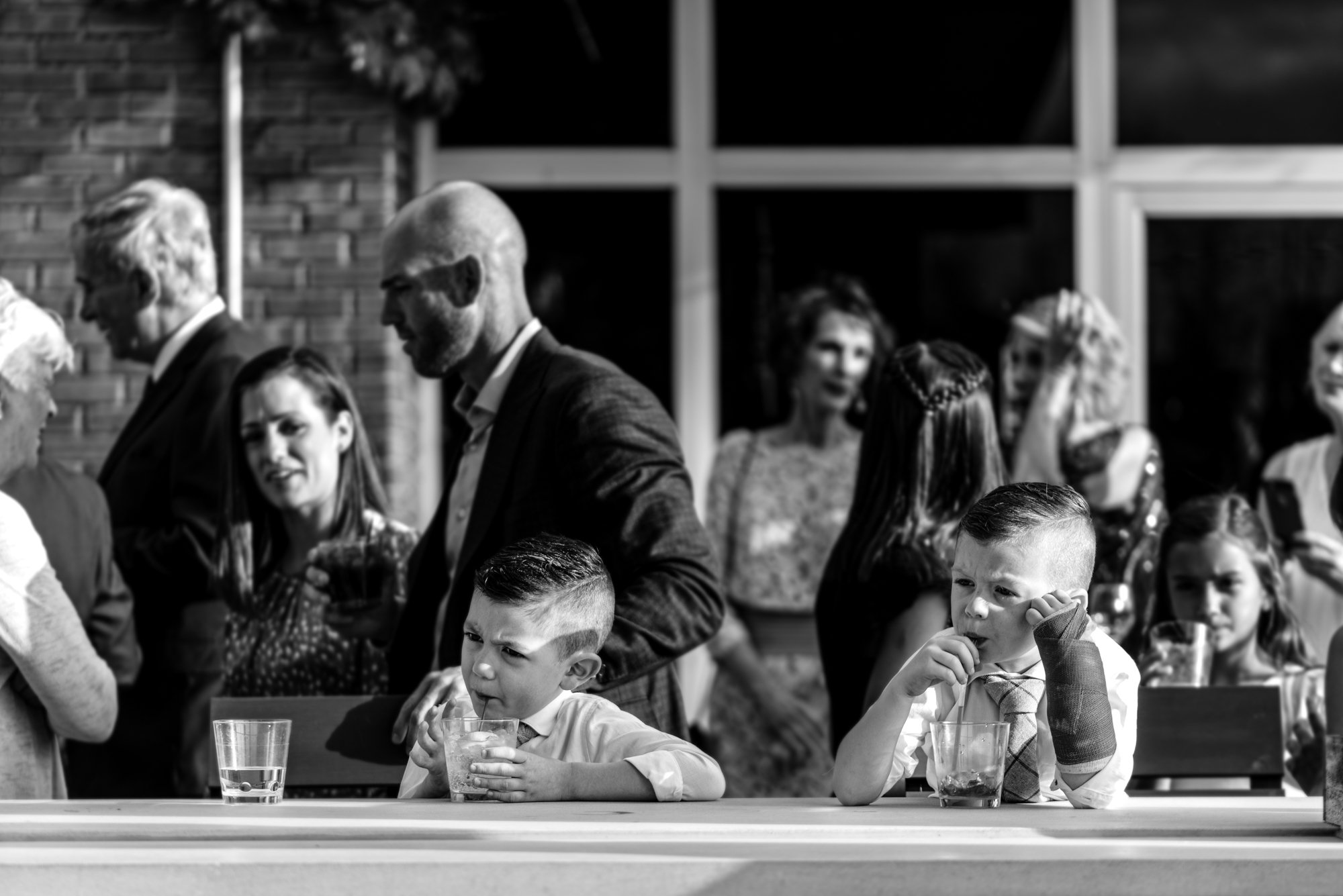 Two boys get a drink at the bar during a cocktail hour at a Wedding in Milwaukee, WI.