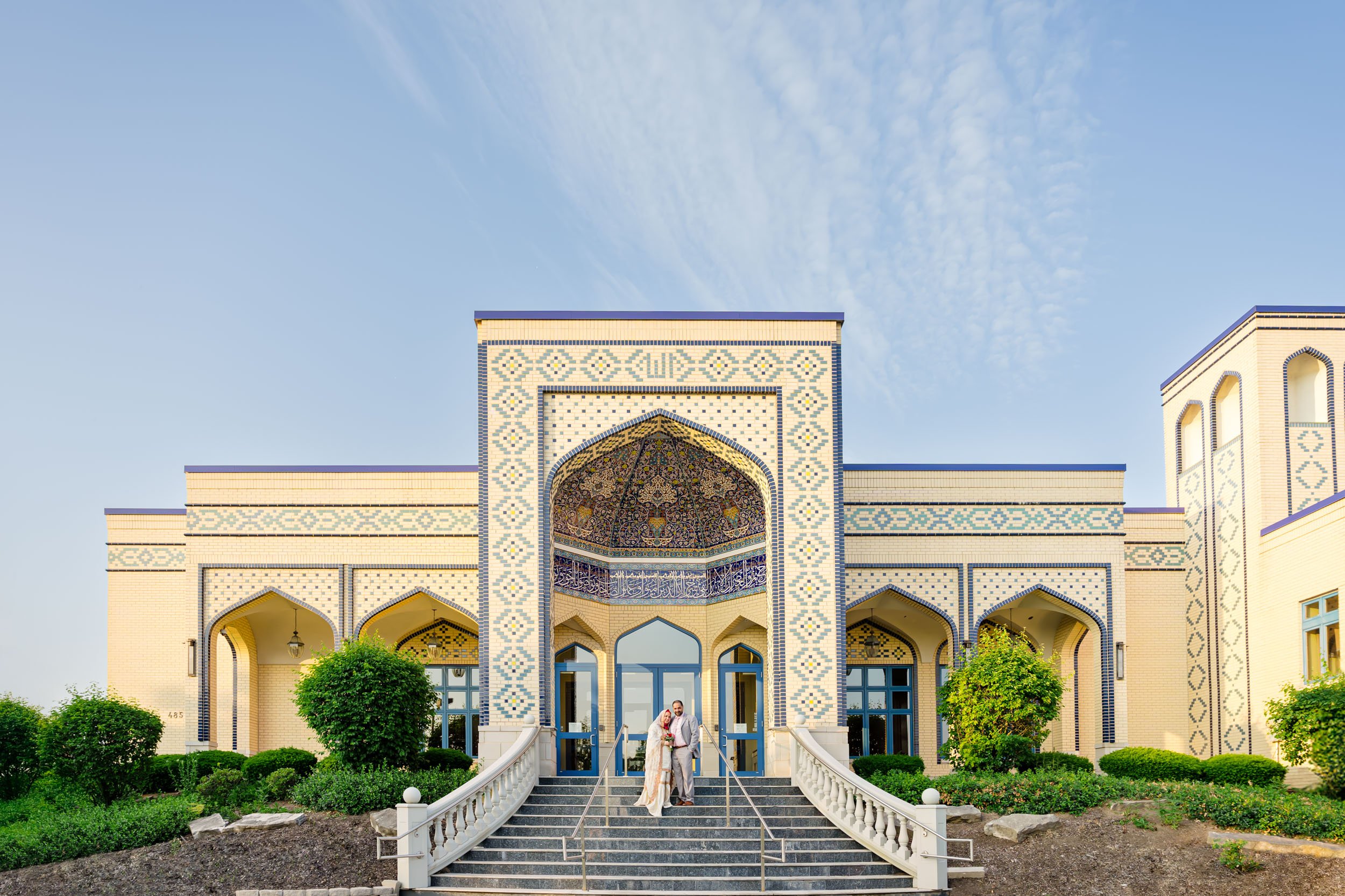A couple poses on the steps of thier Mosque in Streamwood, IL.