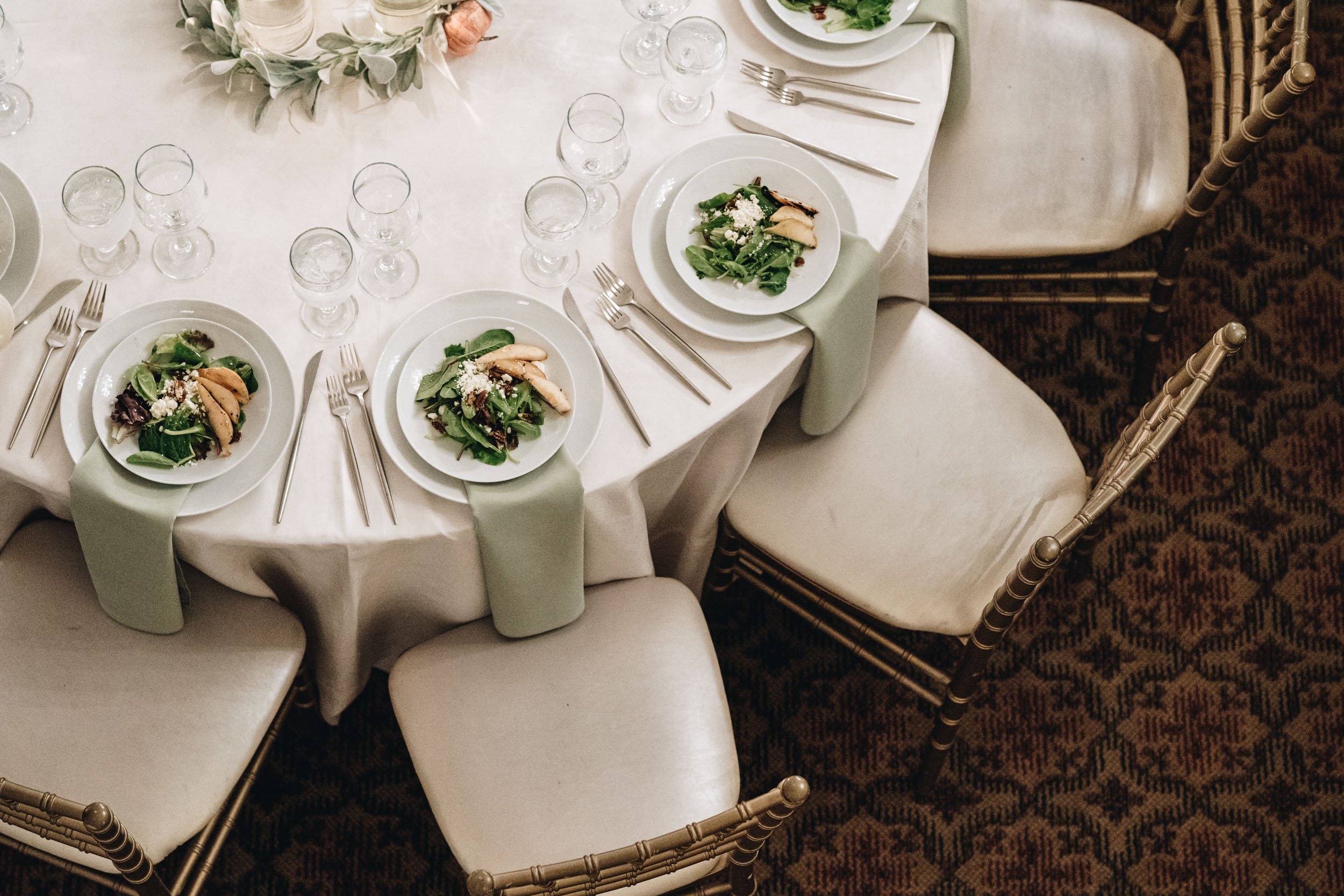 A detail of a table setup wih salads plated at a Chicago wedding.