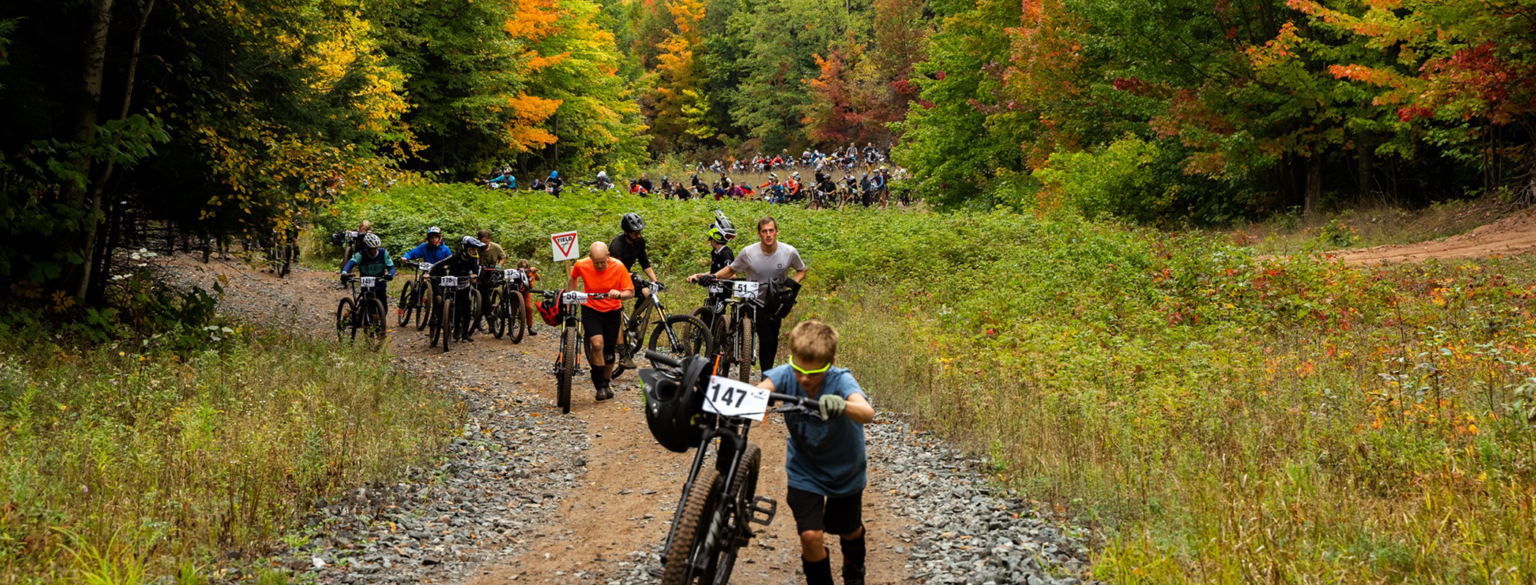 Riders pushing their bikes up Benson