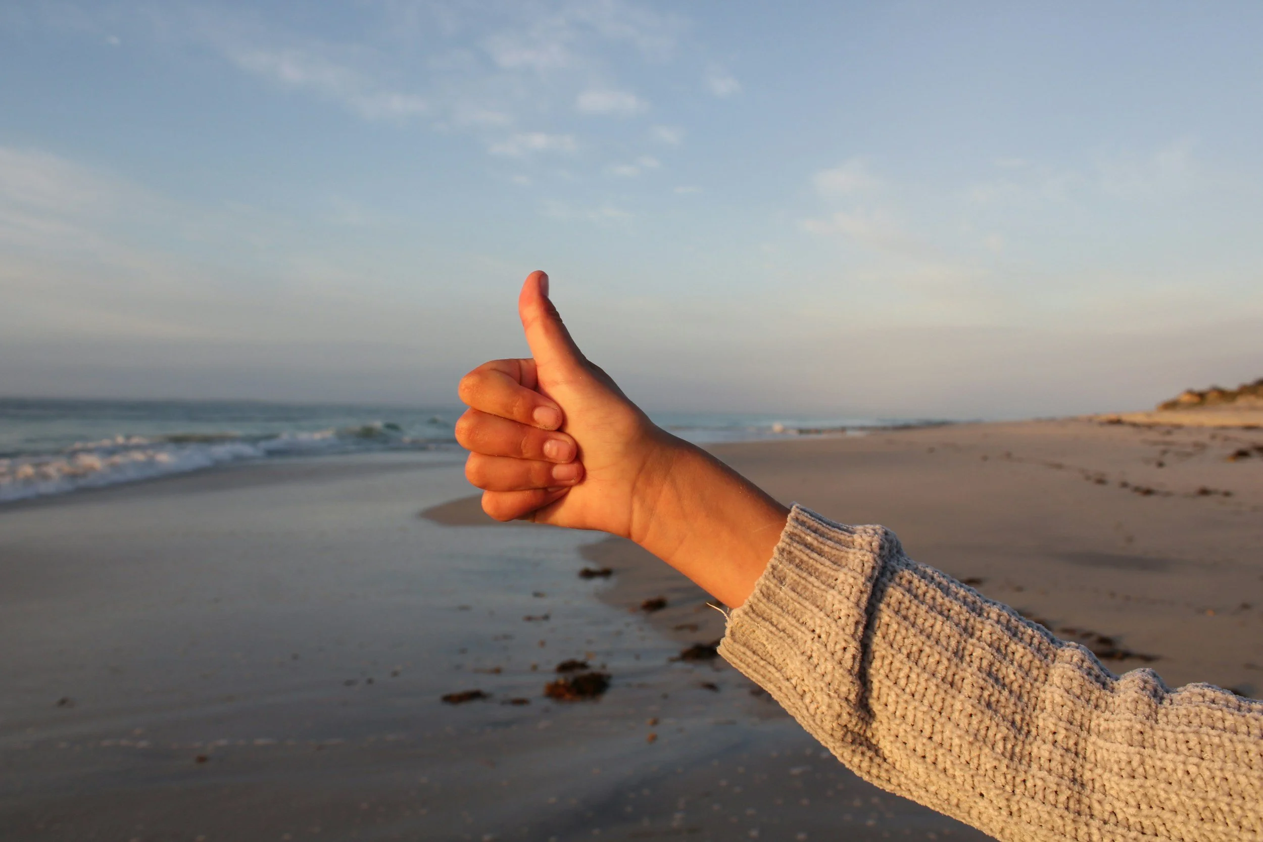 a person holding their thumbs up