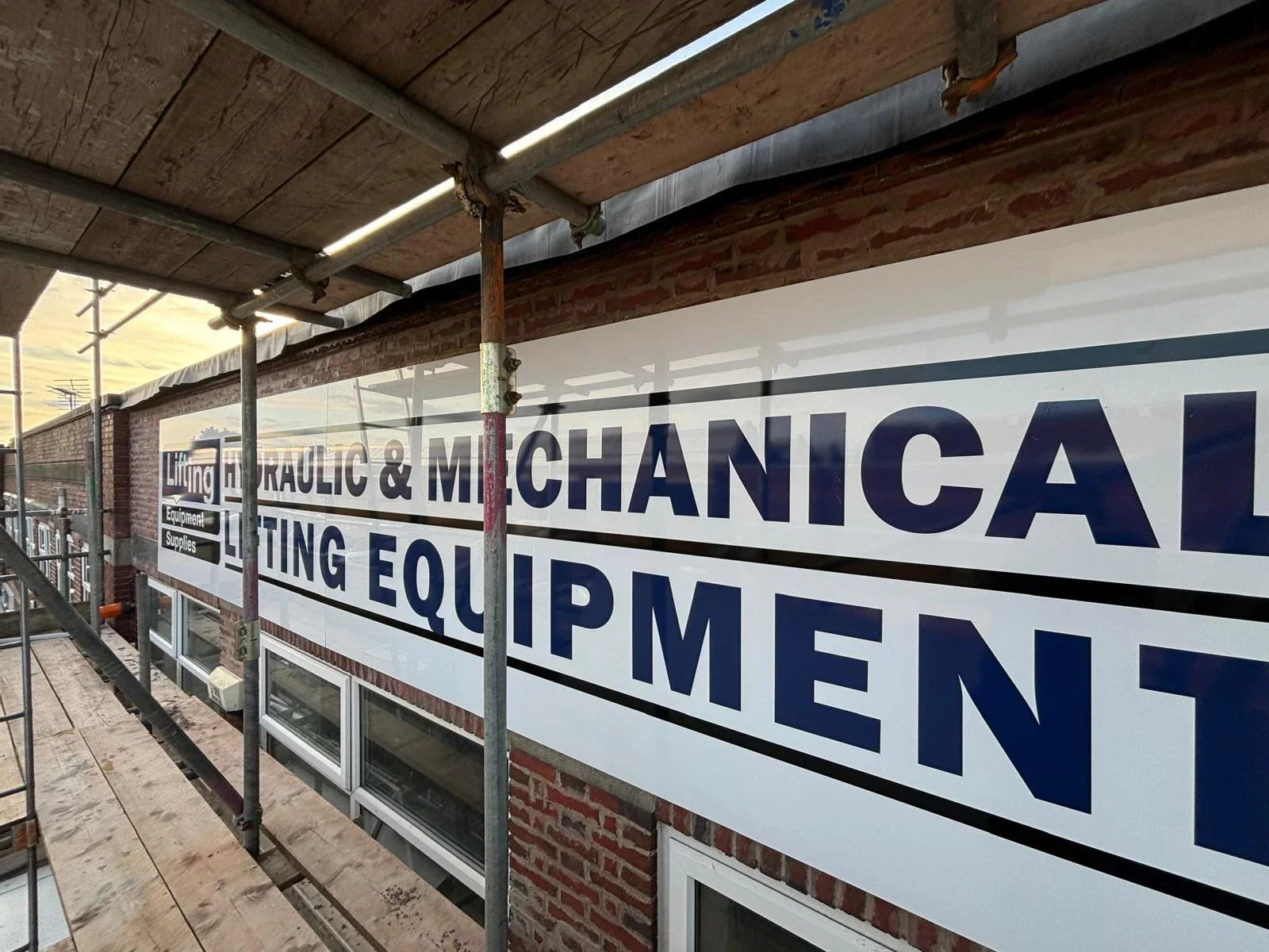 Large industrial unit sign fitted onto brickwork