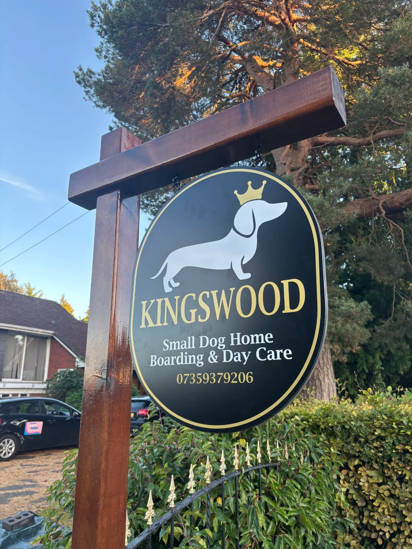 Premium wooden swing sign with a dark gloss finish