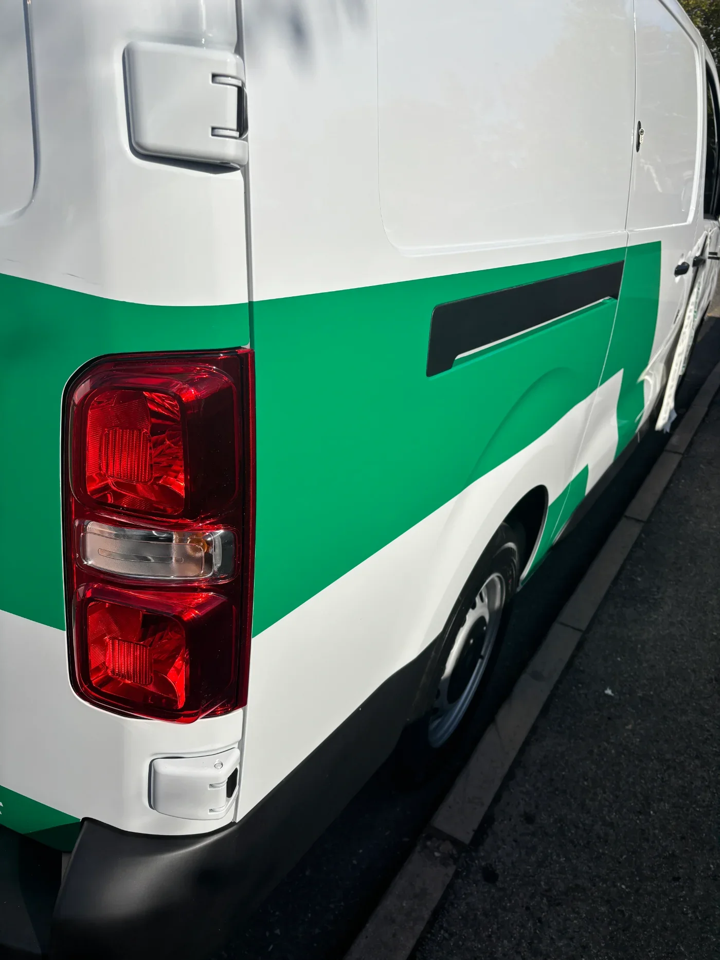 Green wrapped elements on branded company van in Coventry