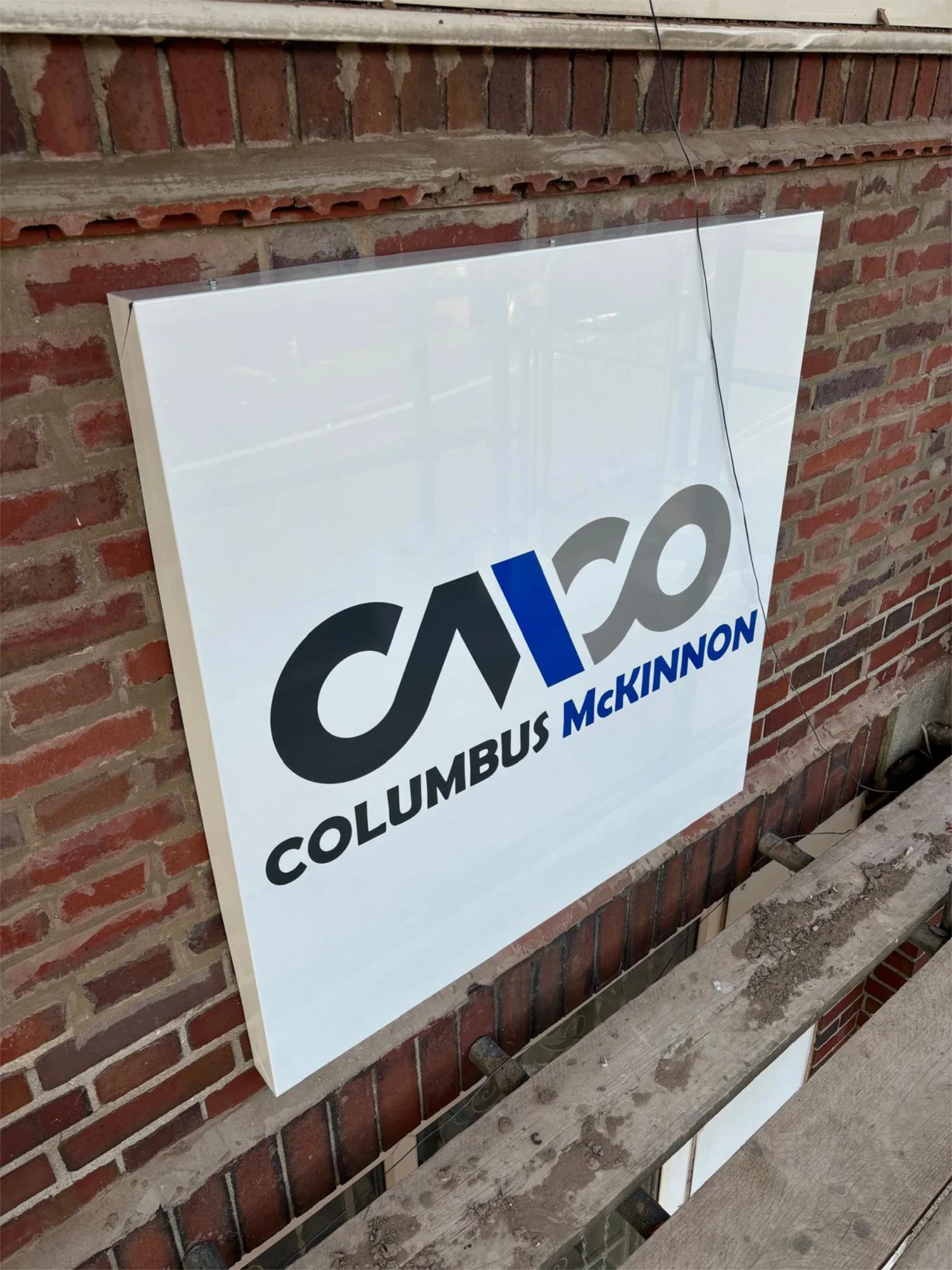 Square box sign with company logo on building exterior in Coventry