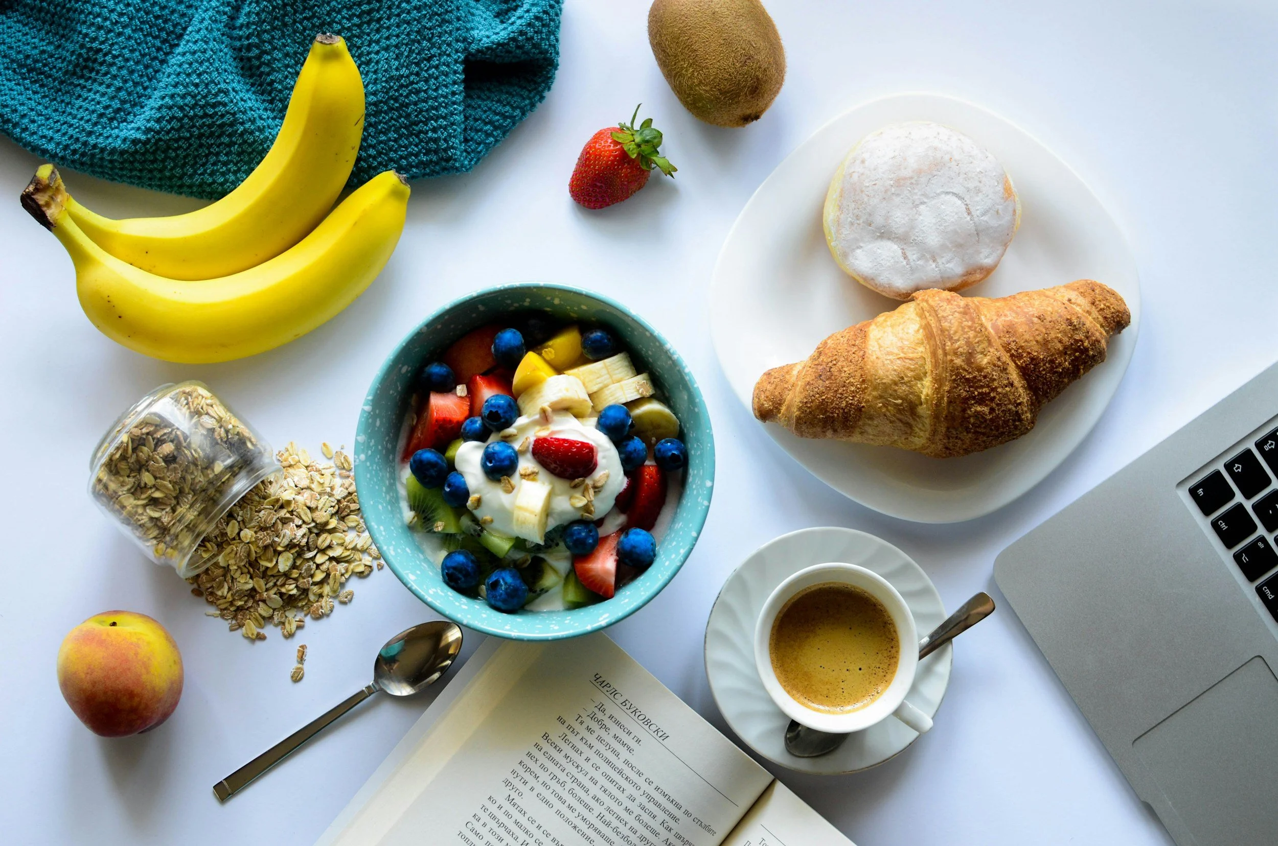 a breakfast assortment with yogurt, bread and fruit
