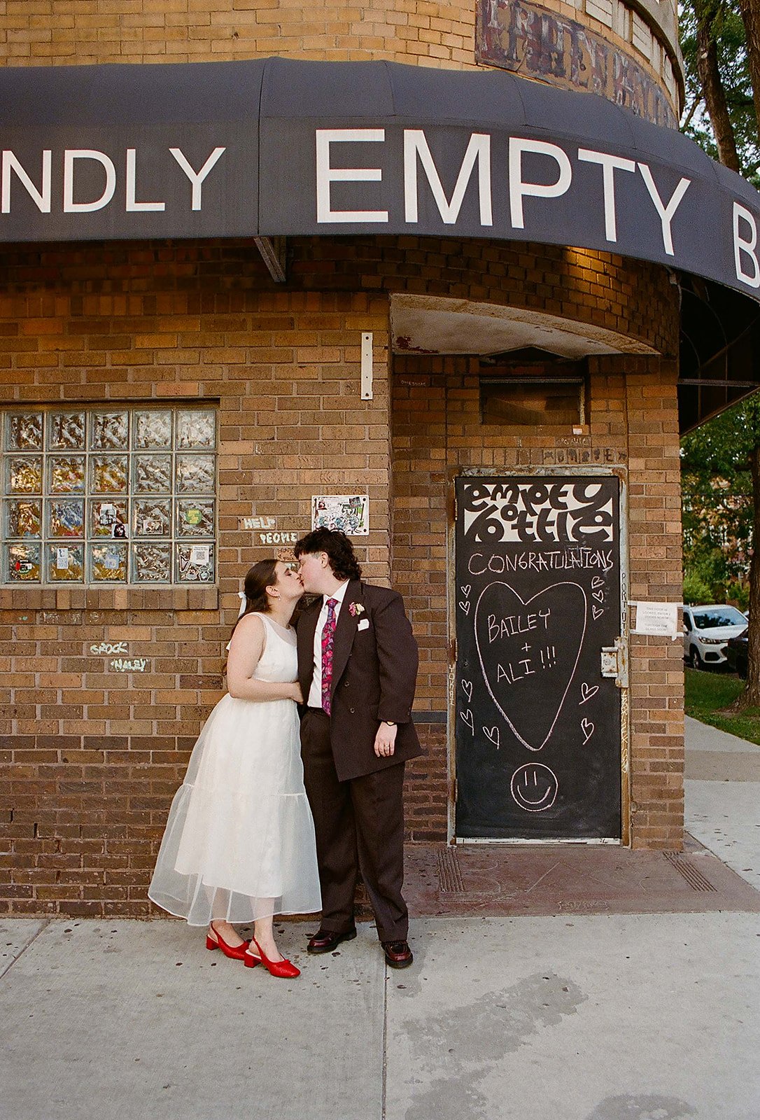 Queer couple gets married in Chicago at the empty bottle with creative, lively wedding focused on community, family, laughter. Documentary and candid photos on analog nostalgic film. Weddings by Grace is a Chicago lesbian queer luxury wedding photogr