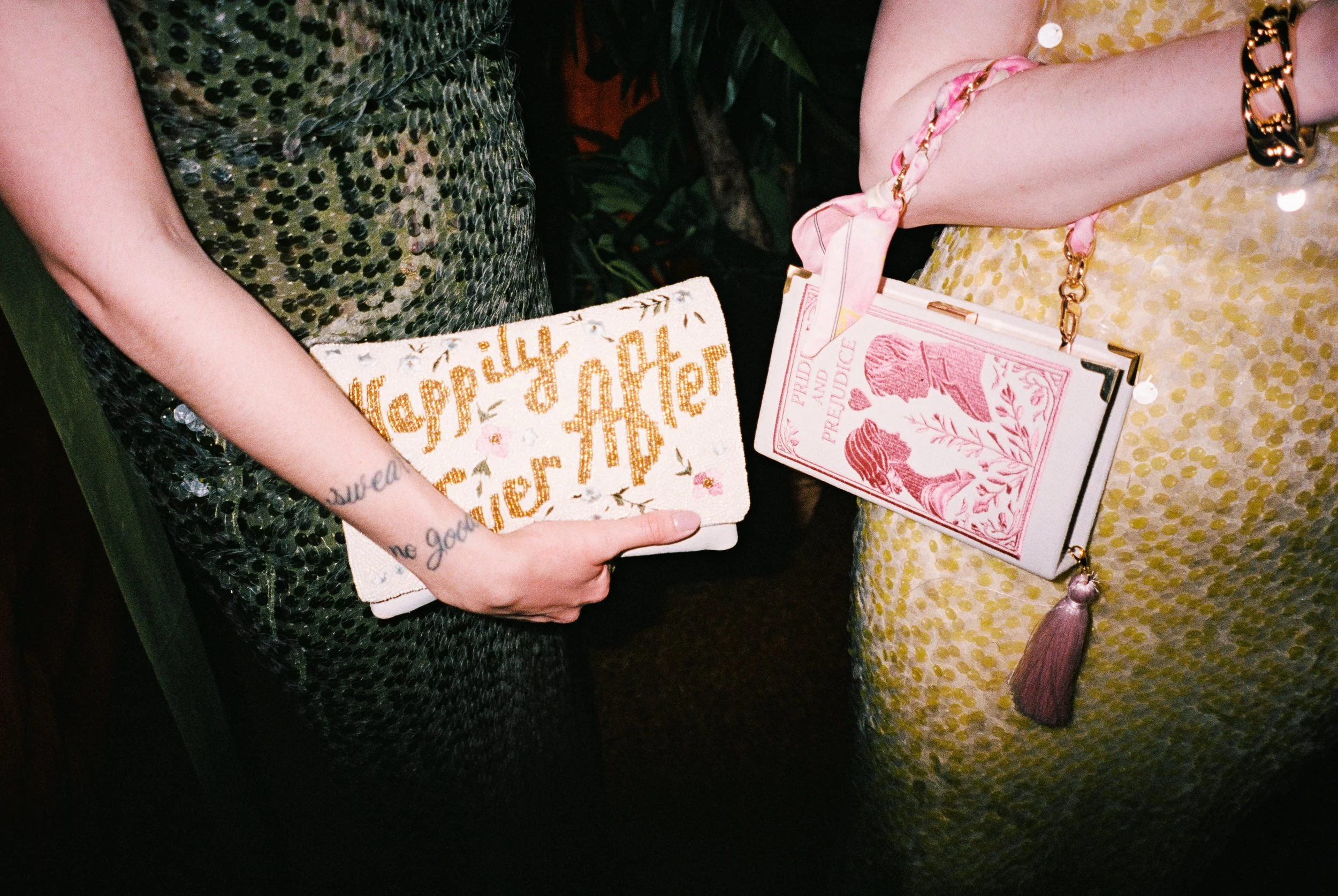 Fun film photo of guests holding colorful purses. Luxury, high-end wedding photographer shot on film. Weddings by grace is a Chicago lesbian queer photographer specializing in portraits, candid, editorial, documentary, + artistic images.