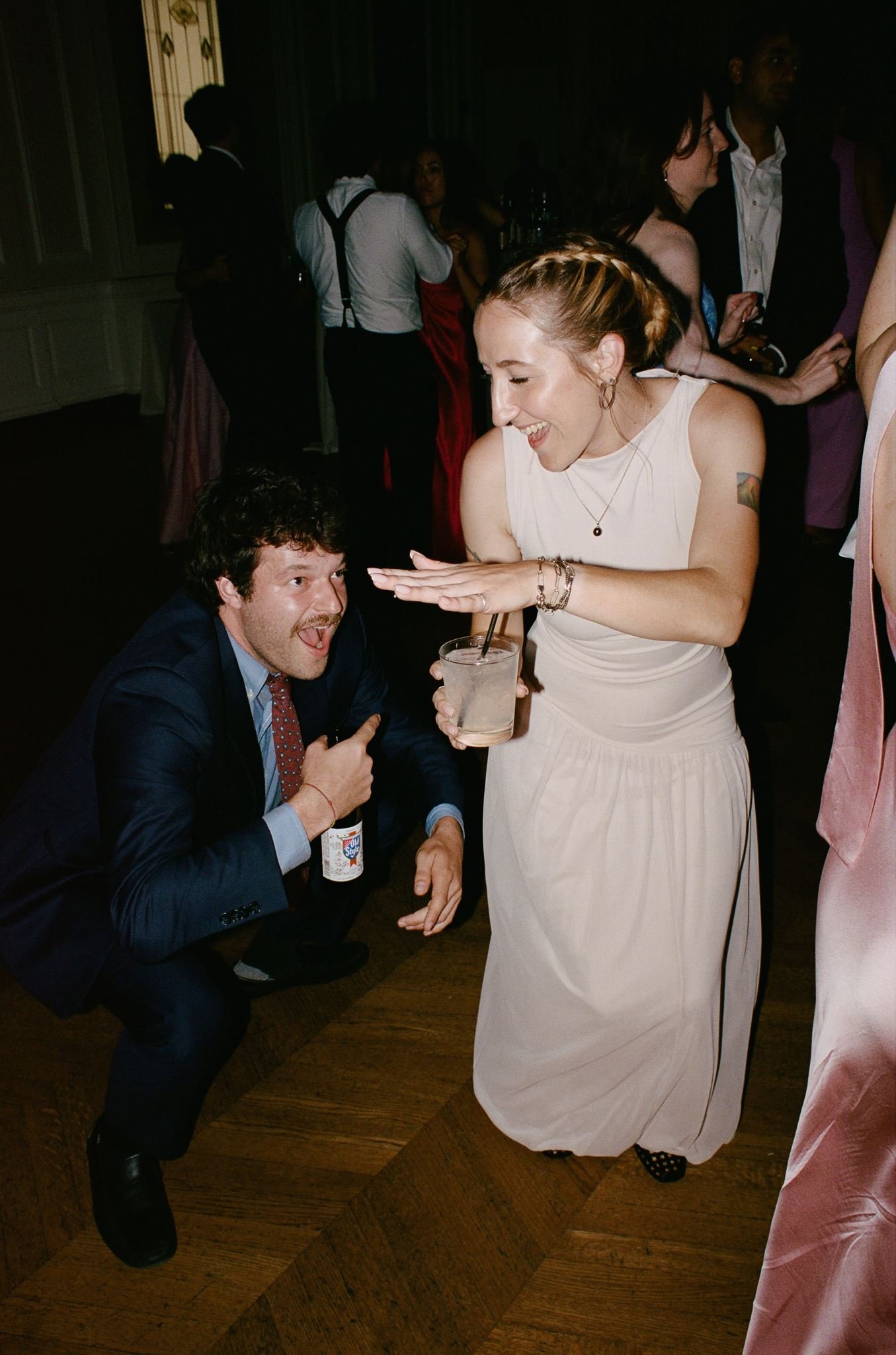 Bride and groom get married at the Chicago History Museum, with creative, lively wedding focused on community, family, laughter. Documentary and candid photos on analog nostalgic film. Weddings by Grace is a Chicago lesbian queer luxury wedding photo