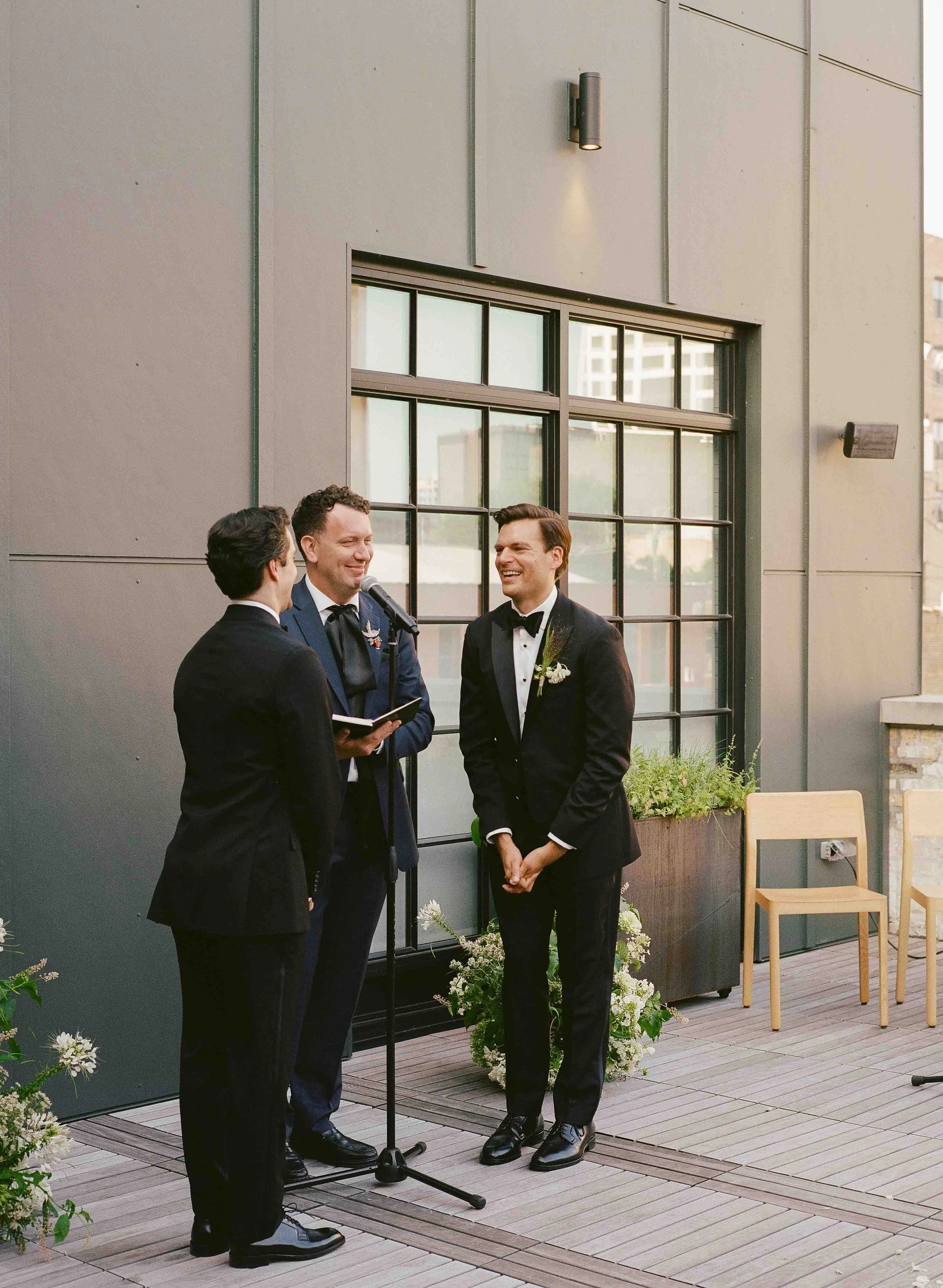 Groom and groom get married at maxwells trading with creative, lively wedding focused on community, queer family, laughter. Documentary and candid photos on analog nostalgic film. Weddings by Grace is a Chicago lesbian queer luxury wedding photograph