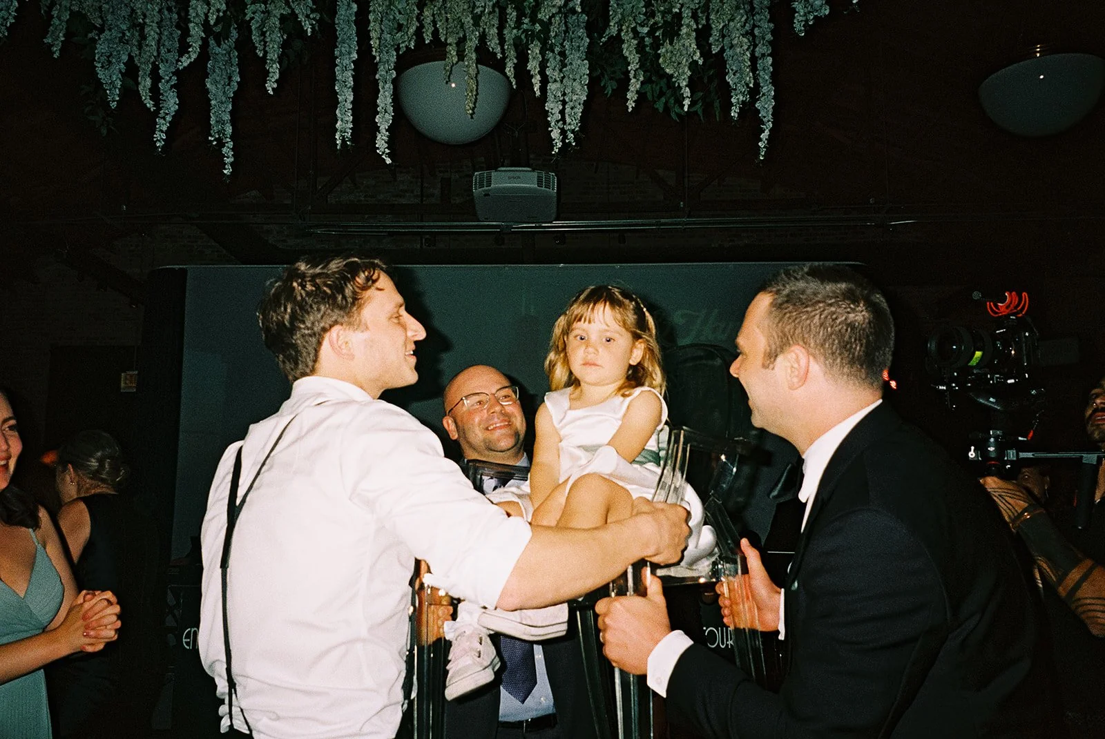 Bride and groom get married in Chicago at WildmanBT, with creative, lively wedding focused on community, family, laughter. Documentary and candid photos on flash film. Weddings by Grace is a Chicago lesbian queer luxury wedding photographer specializ