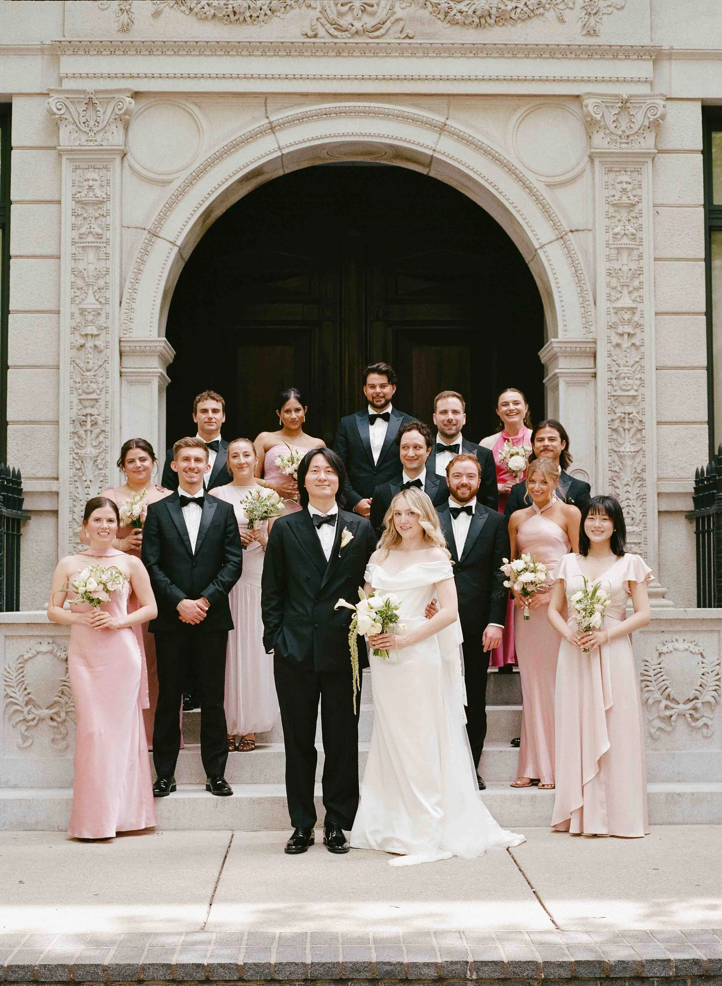 Bride and groom get married at the Chicago History Museum, with creative, lively wedding focused on community, family, laughter. Documentary and candid photos on analog nostalgic film. Weddings by Grace is a Chicago lesbian queer luxury wedding photo
