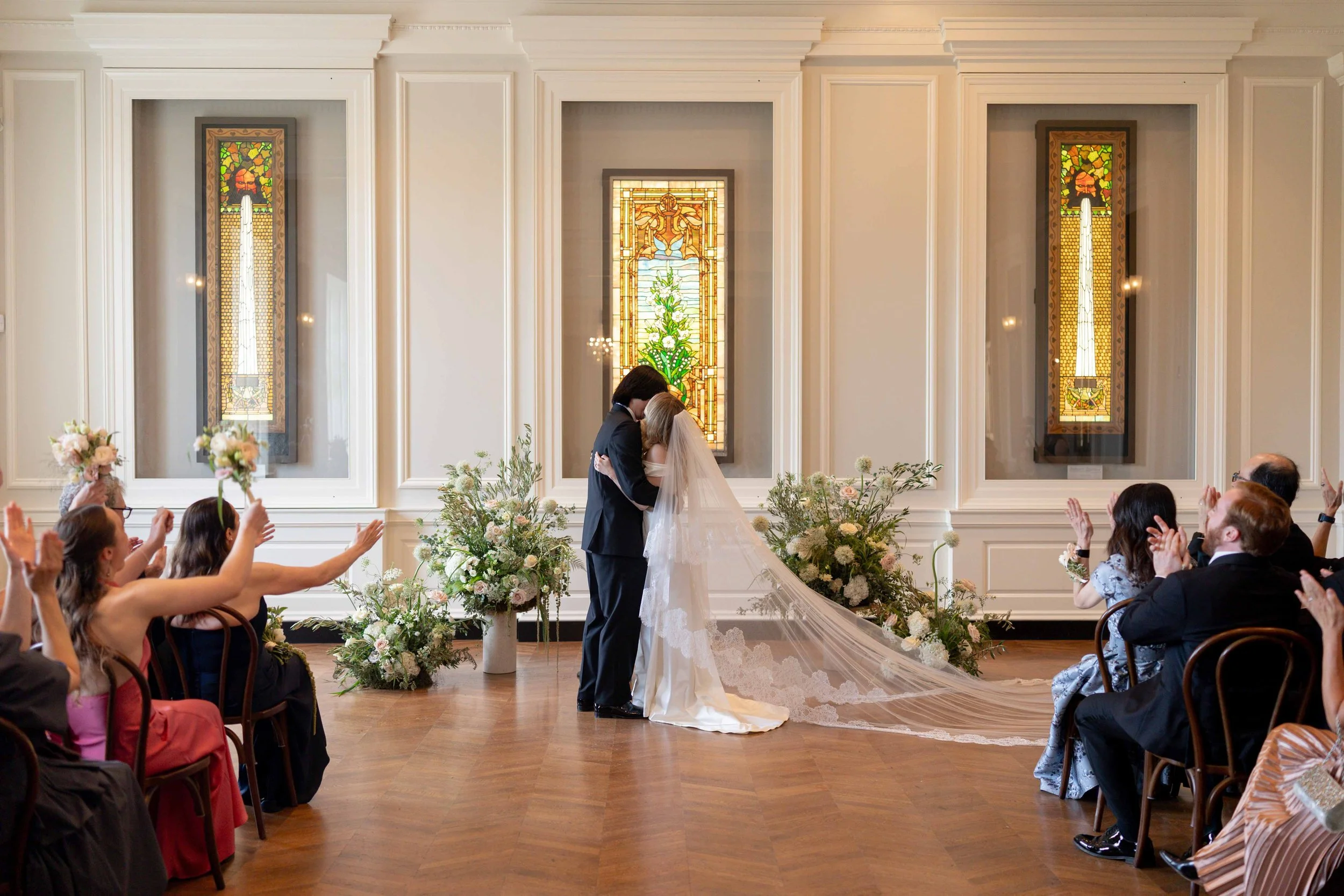 Bride and groom get married at the Chicago History Museum, with creative, lively wedding focused on community, family, laughter. Documentary and candid photos on analog nostalgic film. Weddings by Grace is a Chicago lesbian queer luxury wedding photo