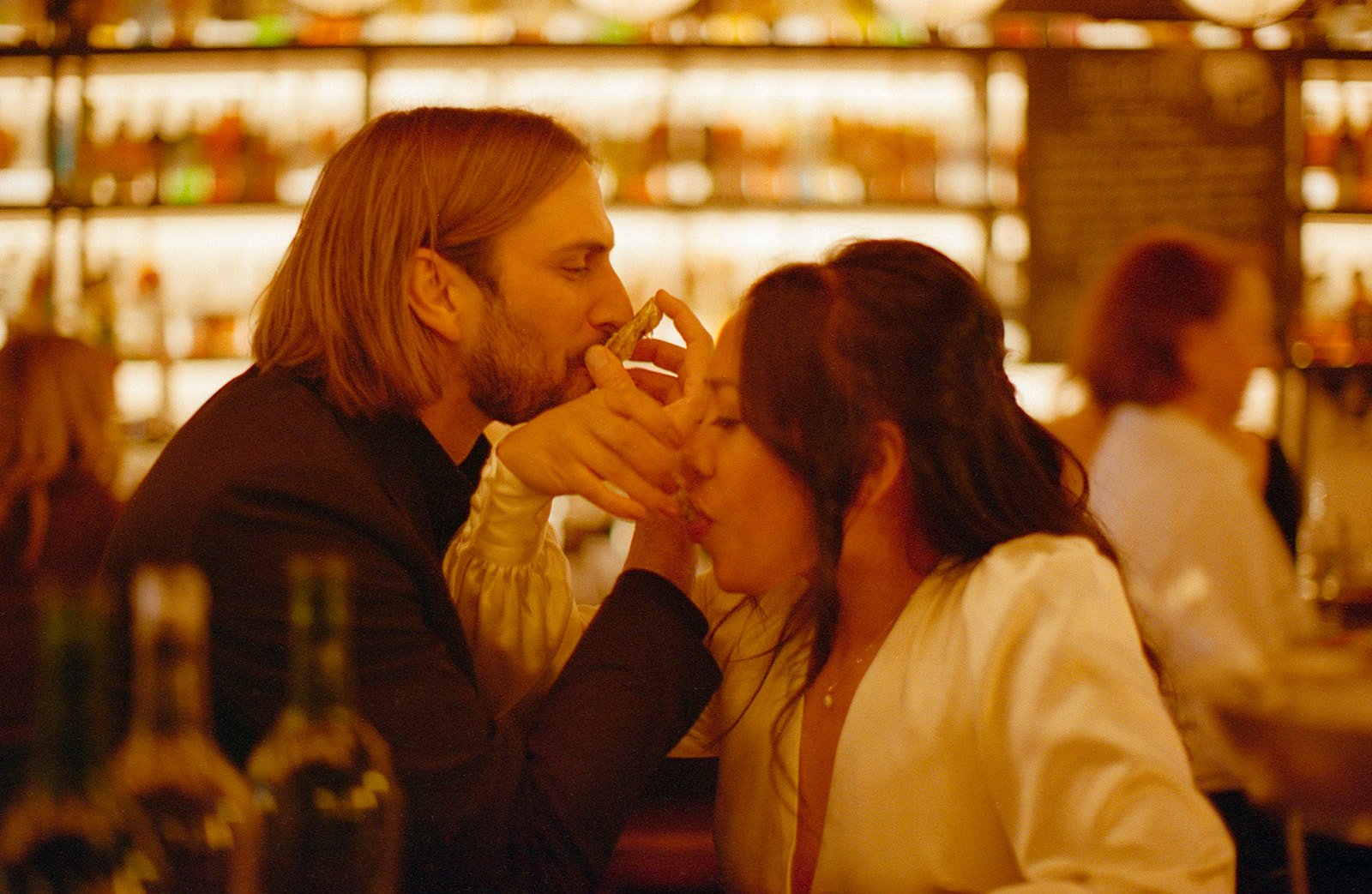bride and groom eat oyster shots after eloping at City Hall downtown chicago. Grace Coudal is a Chicago lesbian photographer specializing in portraits, candid, editorial, documentary, events, + weddings. Analog film wedding photography, queer-owned.