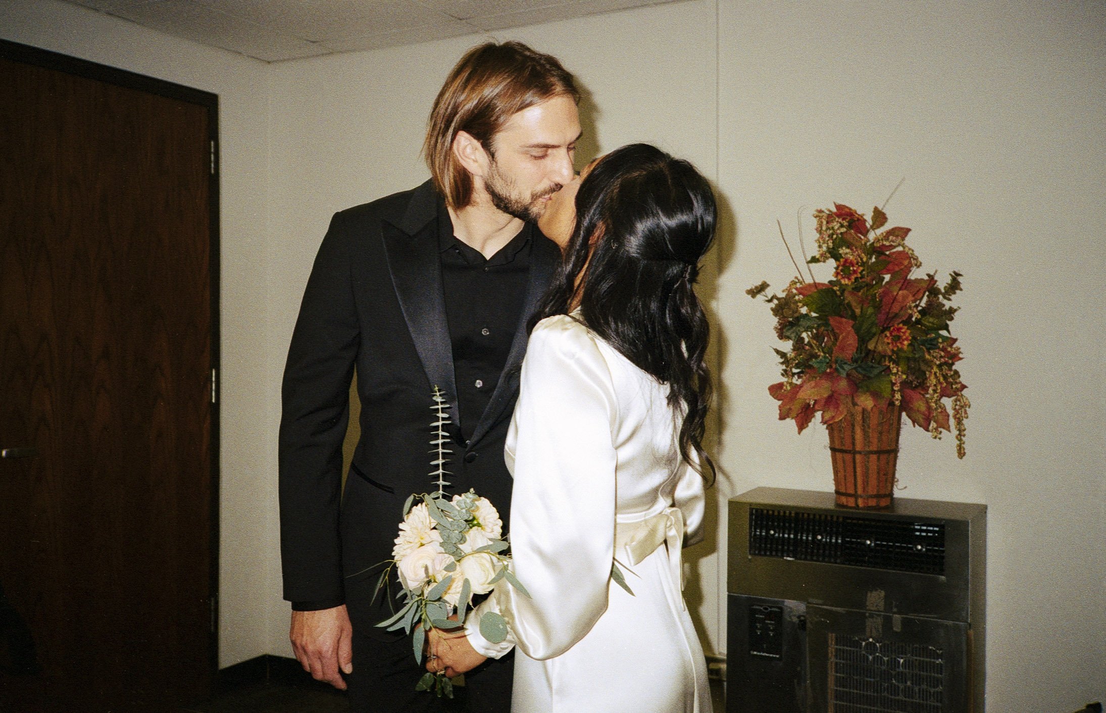 Bride and groom stand at City Hall Elopement in downtown chicago to get married on film. Grace Coudal is a Chicago lesbian photographer specializing in portraits, candid, editorial, documentary, events, + weddings. Analog film wedding photography, qu