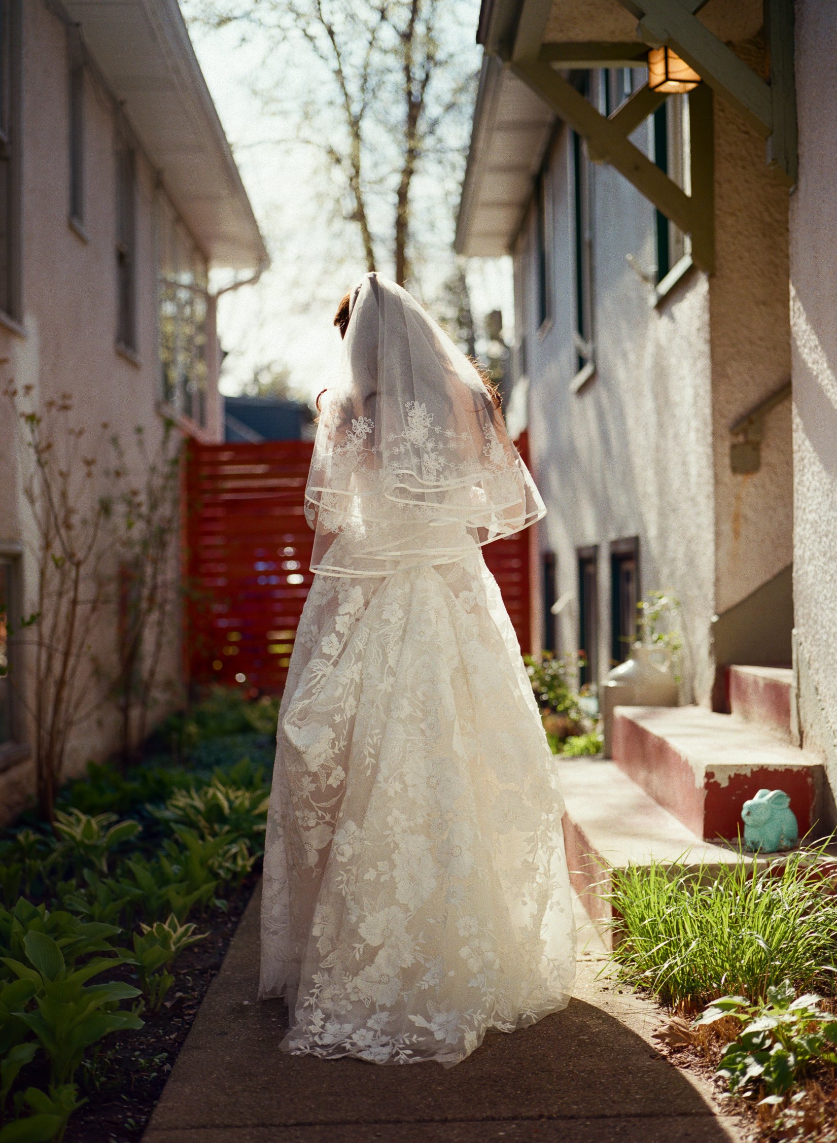 full length photo of brides dress at her childhood home. Bride and Groom get married at Lincoln Park Conservatory and Salvatores. Grace Coudal is a Chicago lesbian photographer specializing in portraits, candid, editorial, documentary, events, + wedd
