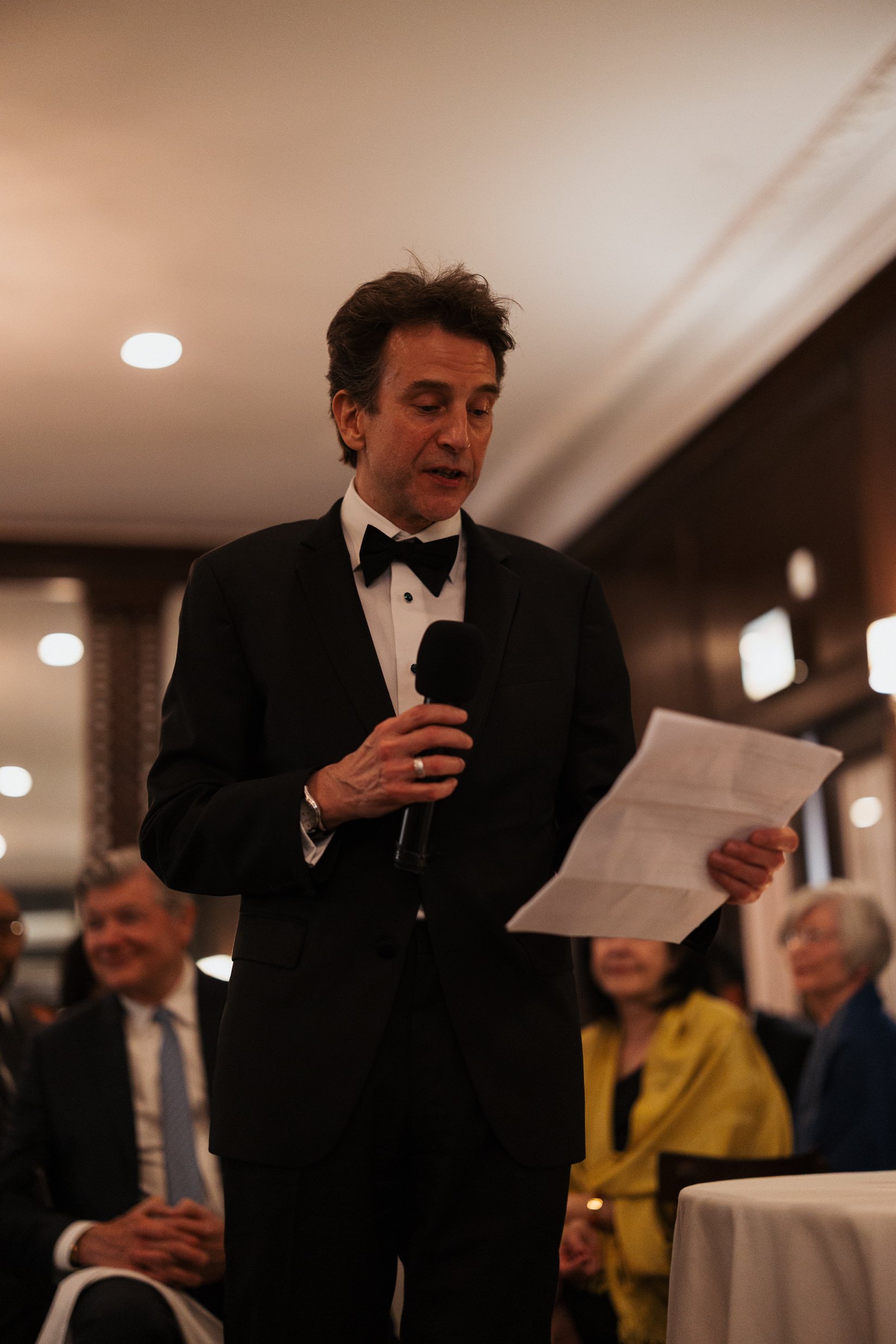 candid ambient light of father giving speech. Bride and Groom marry at Lincoln Park Conservatory and Salvatores. Grace Coudal is a Chicago lesbian photographer specializing in portraits, candid, editorial, documentary, events, + weddings. Analog film
