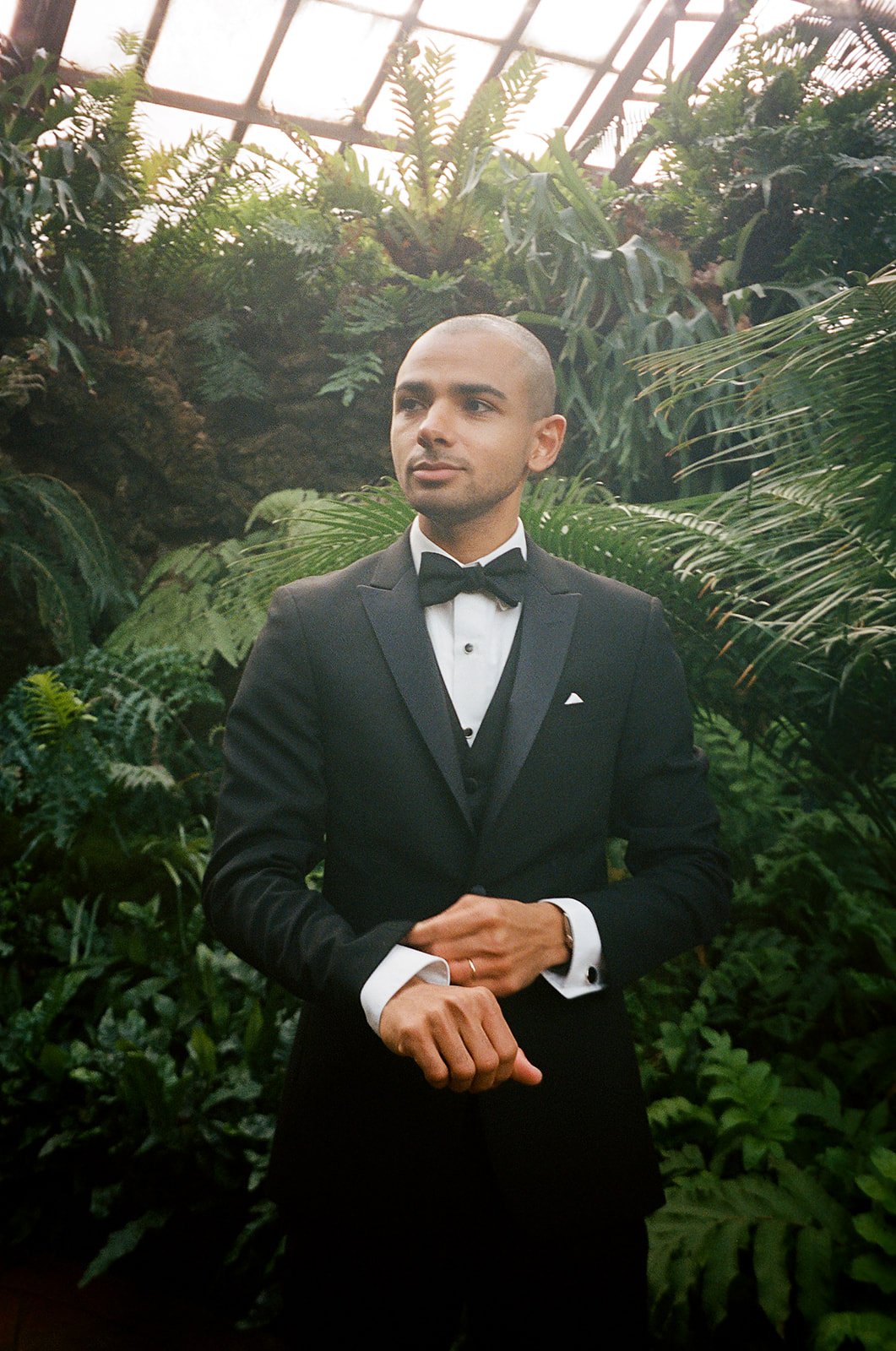 groom getting ready photo. Bride and Groom get married at Lincoln Park Conservatory and Salvatores. Grace Coudal is a Chicago lesbian photographer specializing in portraits, candid, editorial, documentary, events, + weddings. Analog film wedding phot