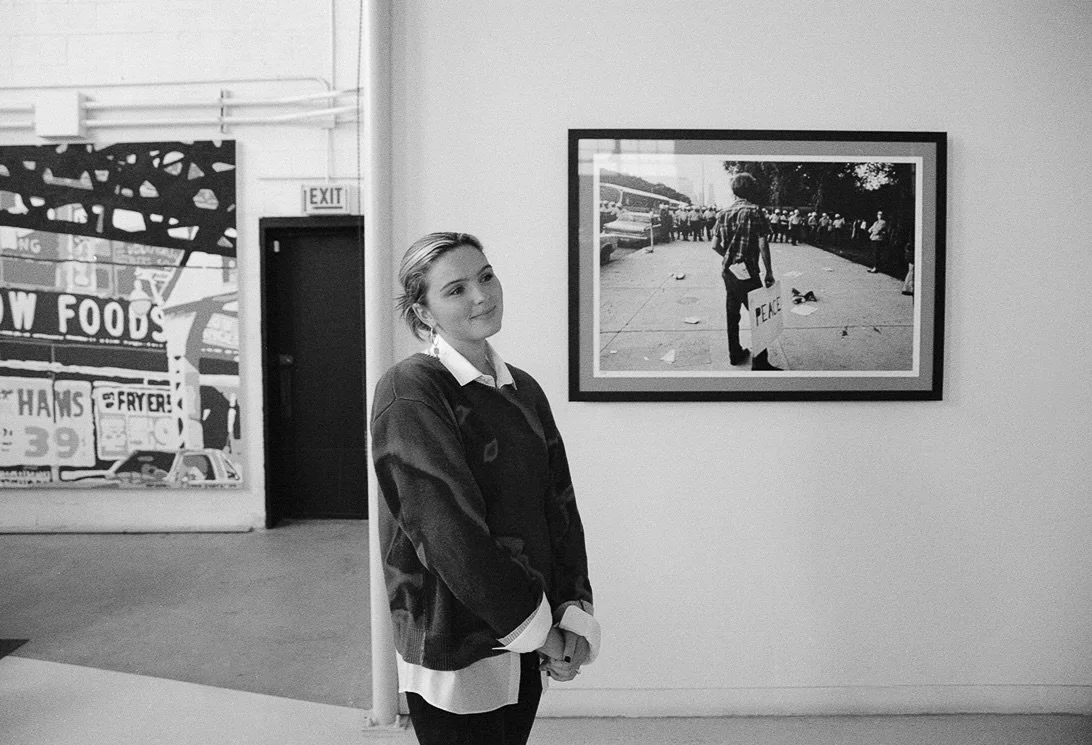 Black and white behind the scenes photos of Grace Coudal on set. She is a Chicago lesbian photographer specializing in portraits, product, food, lifestyle, events, + weddings. Analog film photography, queer-owned.