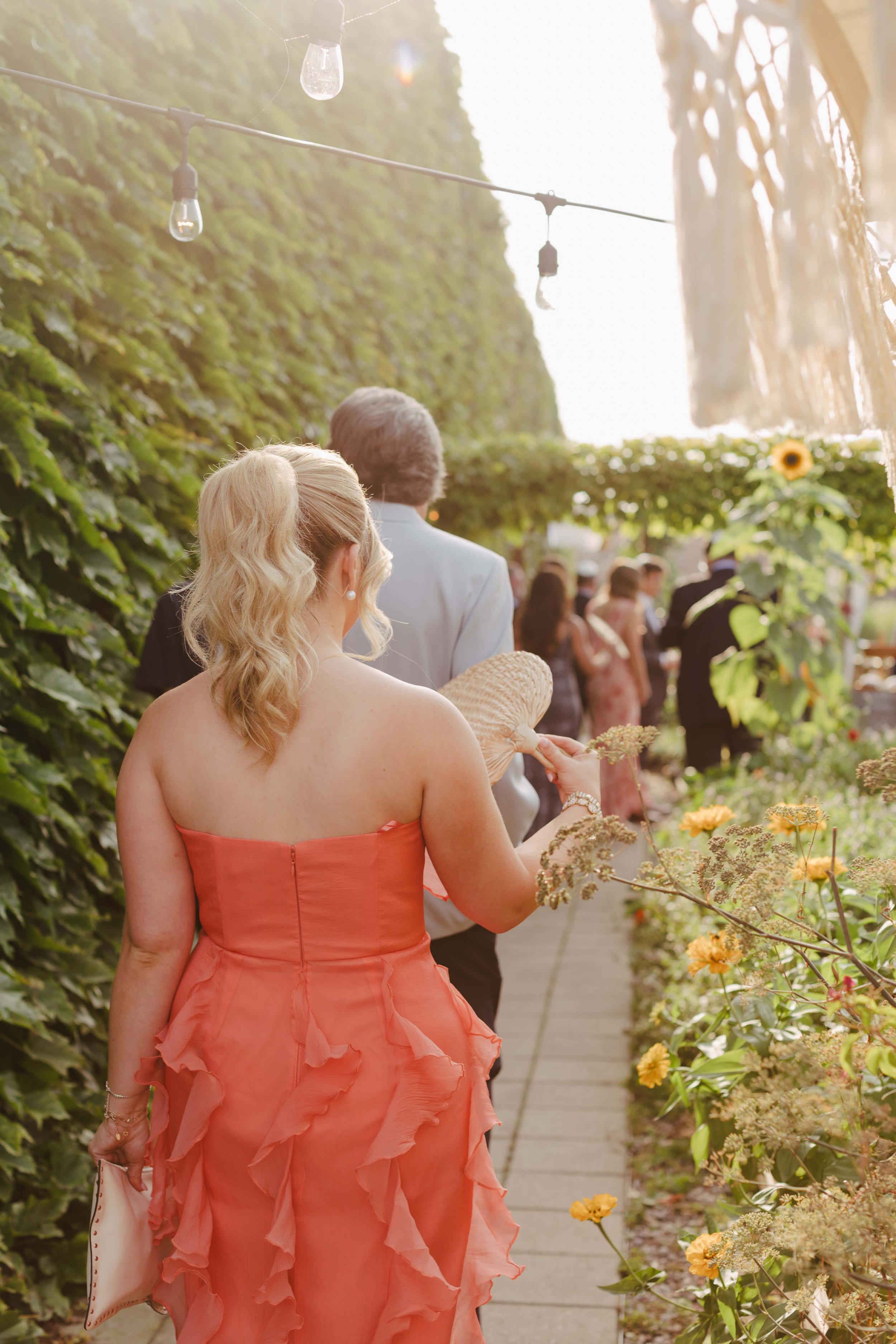 Wedding guests walking into big delicious planet for intimate farm to table wedding. Grace Coudal is a Chicago lesbian photographer specializing in portraits, product, food, lifestyle, events, + weddings. Analog film photography, queer-owned.