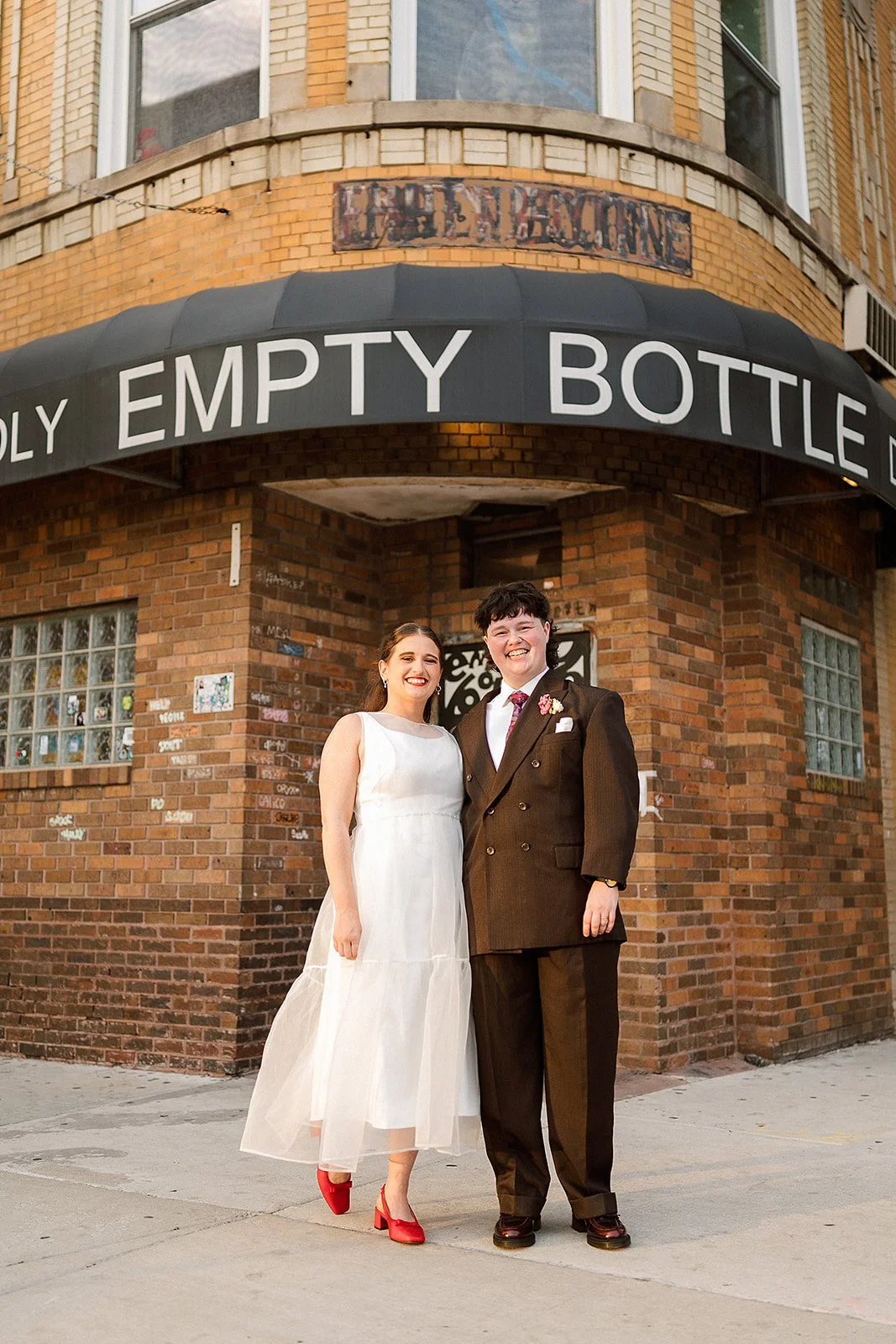 Queer couple gets married in Chicago at the empty bottle with creative, lively wedding focused on community, family, laughter. Documentary and candid photos on analog nostalgic film. Weddings by Grace is a Chicago lesbian queer luxury wedding photogr