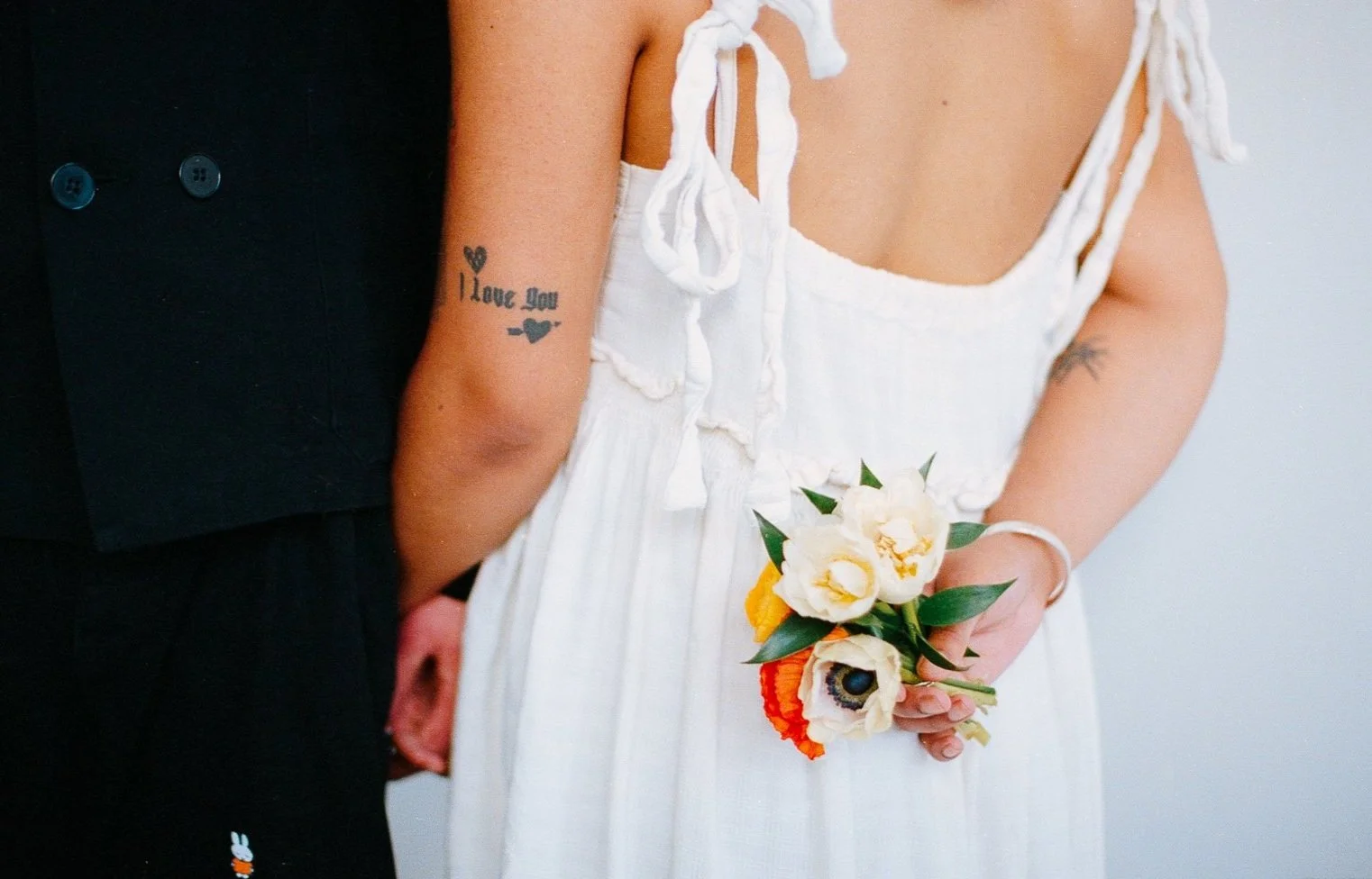 Tattoo detail, wedding photographer shot on film. Grace is a Chicago lesbian photographer specializing in portraits, candid, editorial, documentary, events, + weddings. Analog film wedding photography, queer-owned.