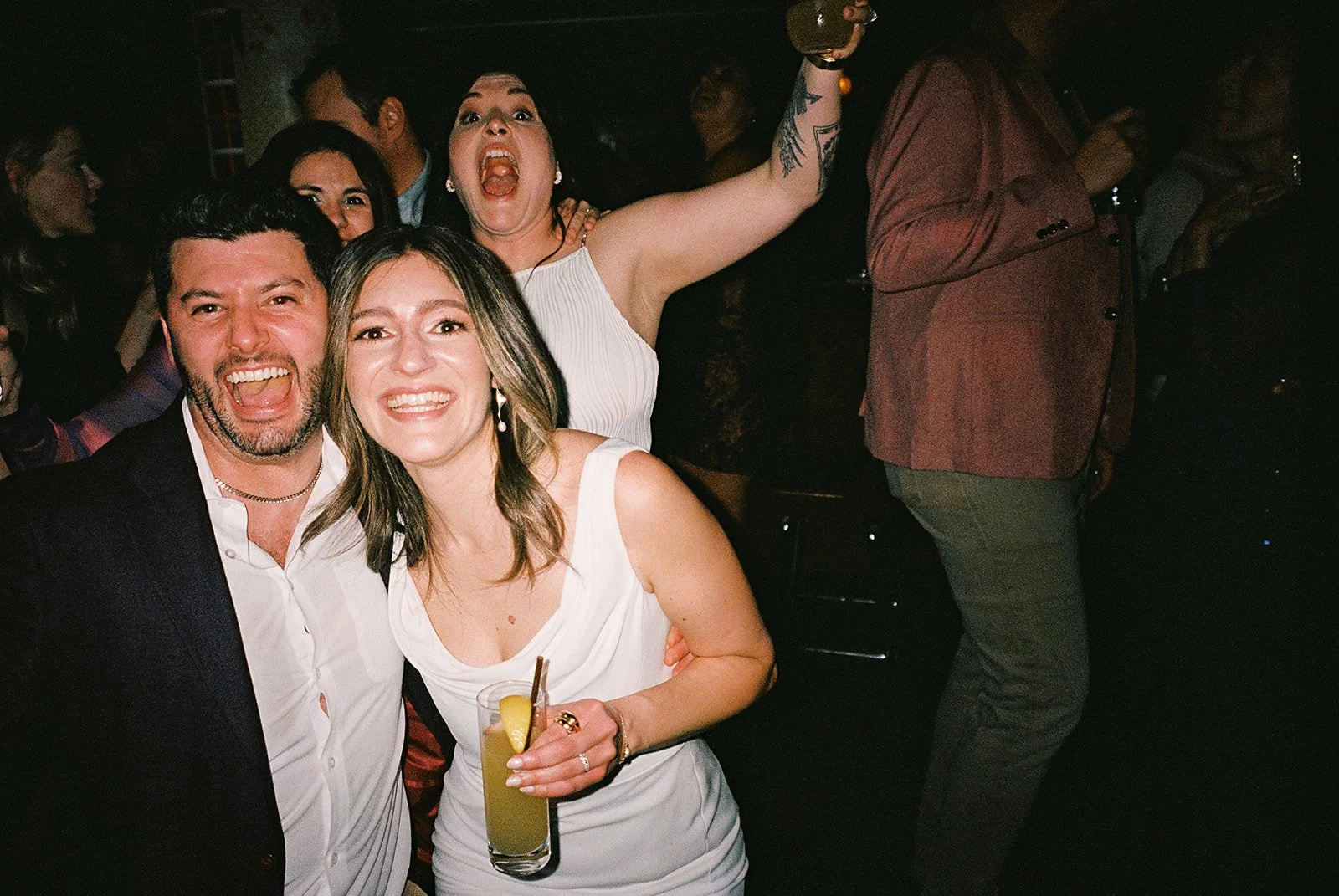 Fun flash photos of lesbian wedding at Dorothy bar. Documentary and candid photos on flash film. Weddings by Grace is a Chicago lesbian queer luxury wedding photographer specializing in portraits, candid, editorial, documentary, + artistic images wit