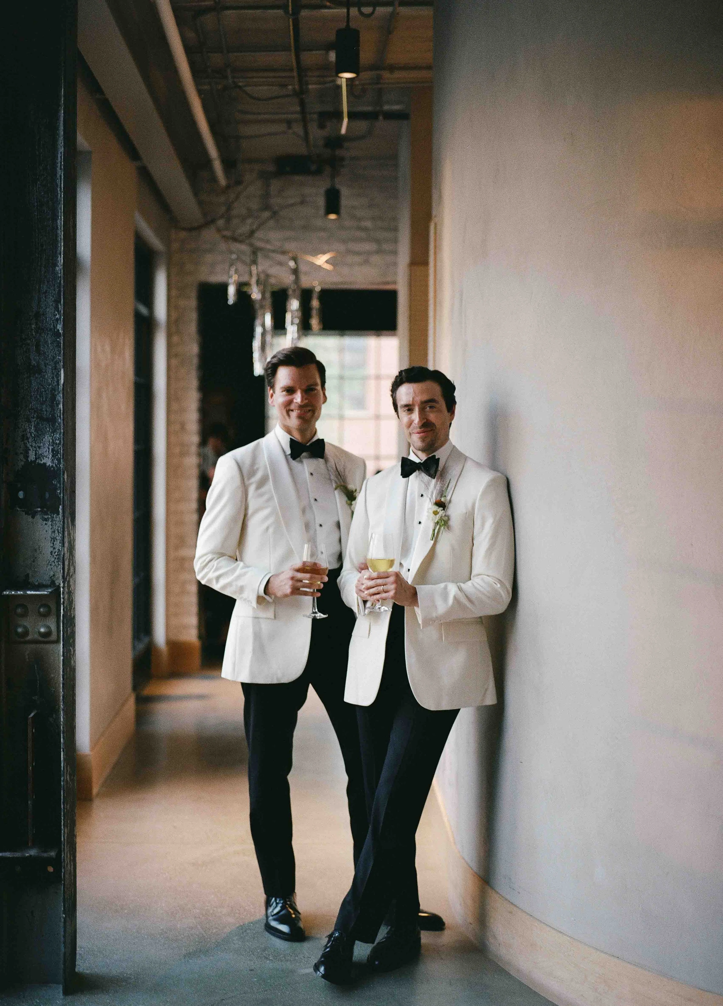 Groom and groom get married at maxwells trading with creative, lively wedding focused on community, queer family, laughter. Documentary and candid photos on analog nostalgic film. Weddings by Grace is a Chicago lesbian queer luxury wedding photograph