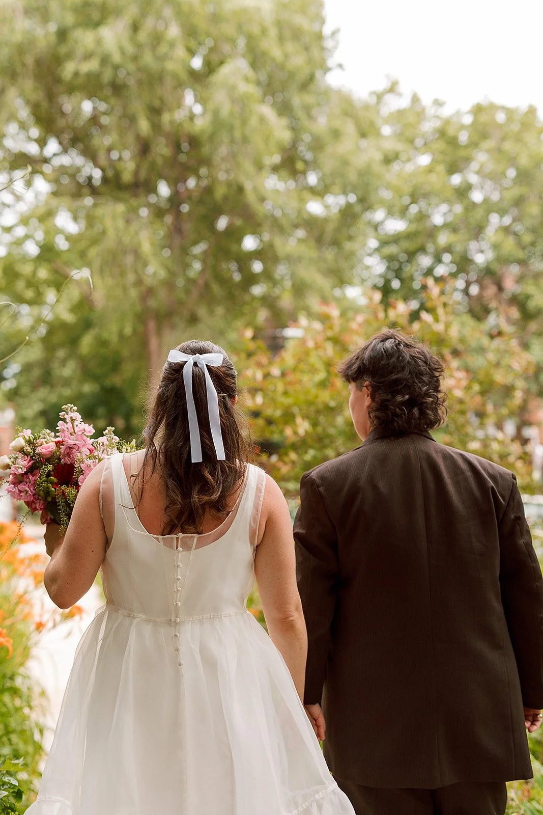Queer couple gets married in Chicago at the empty bottle with creative, lively wedding focused on community, family, laughter. Documentary and candid photos on analog nostalgic film. Weddings by Grace is a Chicago lesbian queer luxury wedding photogr
