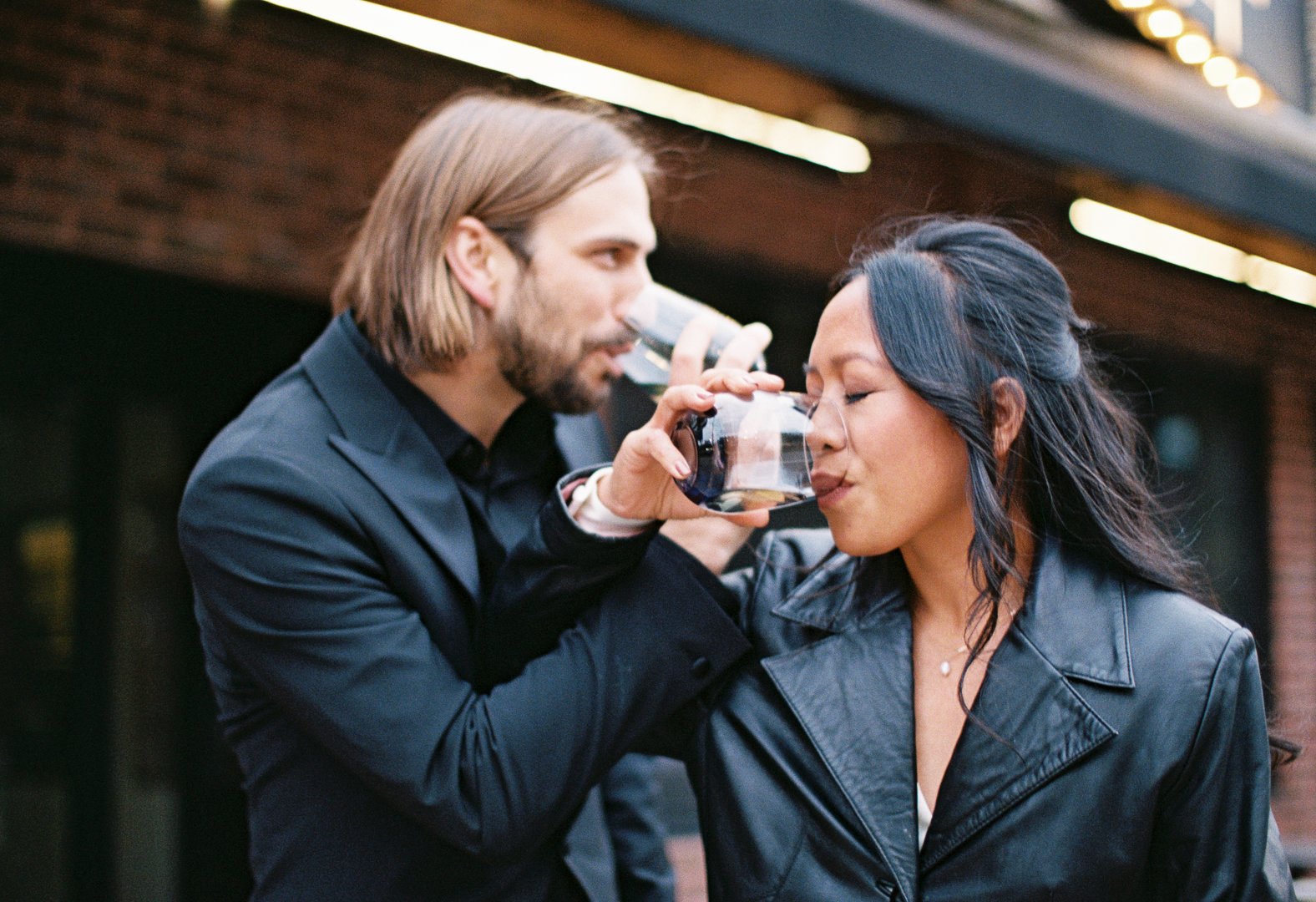 bride and groom get drinks at bbq spot after City Hall Elopement in downtown chicago on film. Grace Coudal is a Chicago lesbian photographer specializing in portraits, candid, editorial, documentary, events, + weddings. Analog film wedding photograph