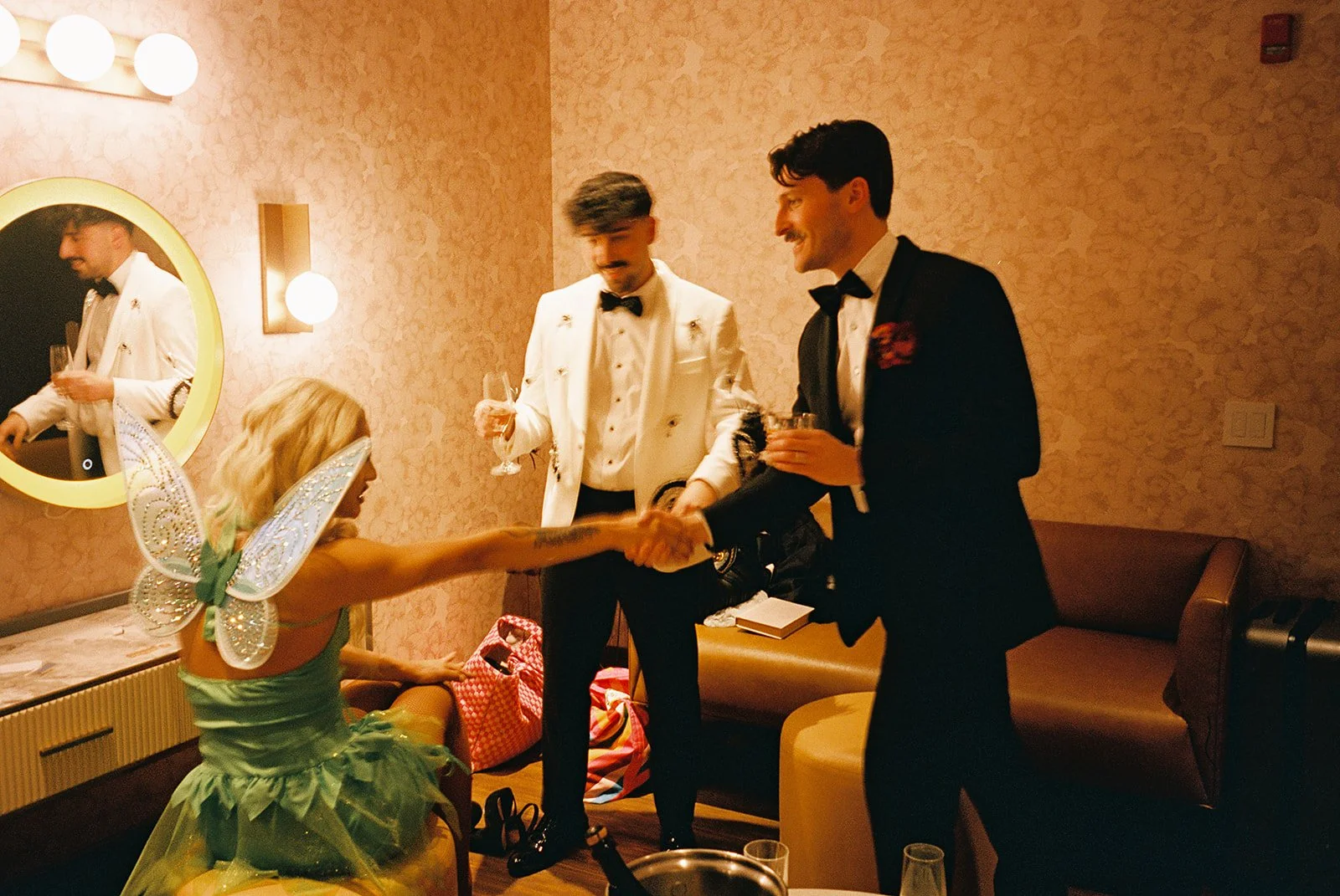 Two grooms get married downtown on Halloween night at chicago winery. Queer, gay, black tie, high-end party and drag show. Documentary and candid photos on flash film. Weddings by Grace is a Chicago lesbian queer luxury wedding photographer specializ