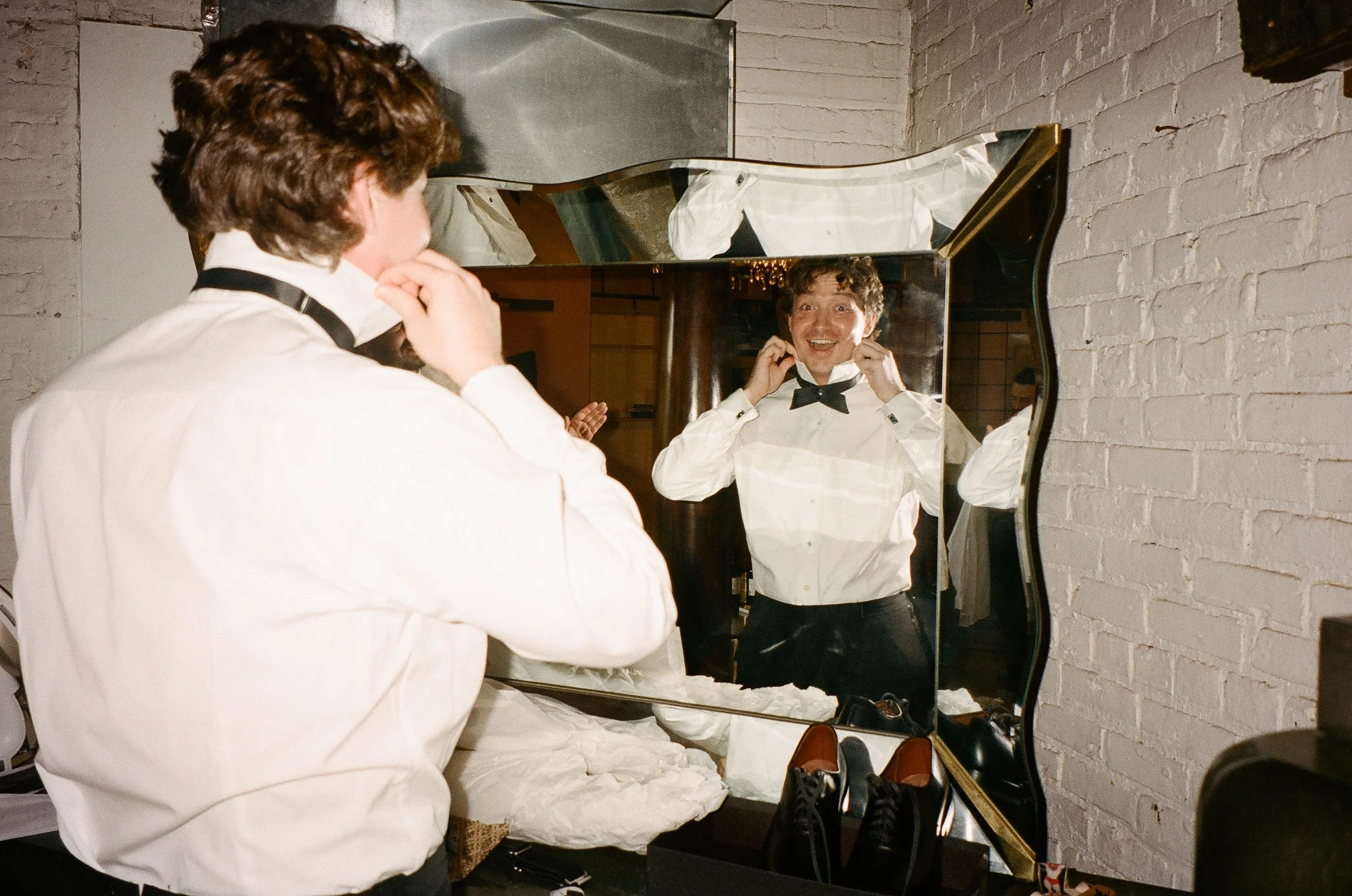 Bride and groom get married in Chicago at Salvage One, with creative, lively wedding focused on community, family, laughter. Documentary and candid photos on analog nostalgic film. Weddings by Grace is a Chicago lesbian queer luxury wedding photograp