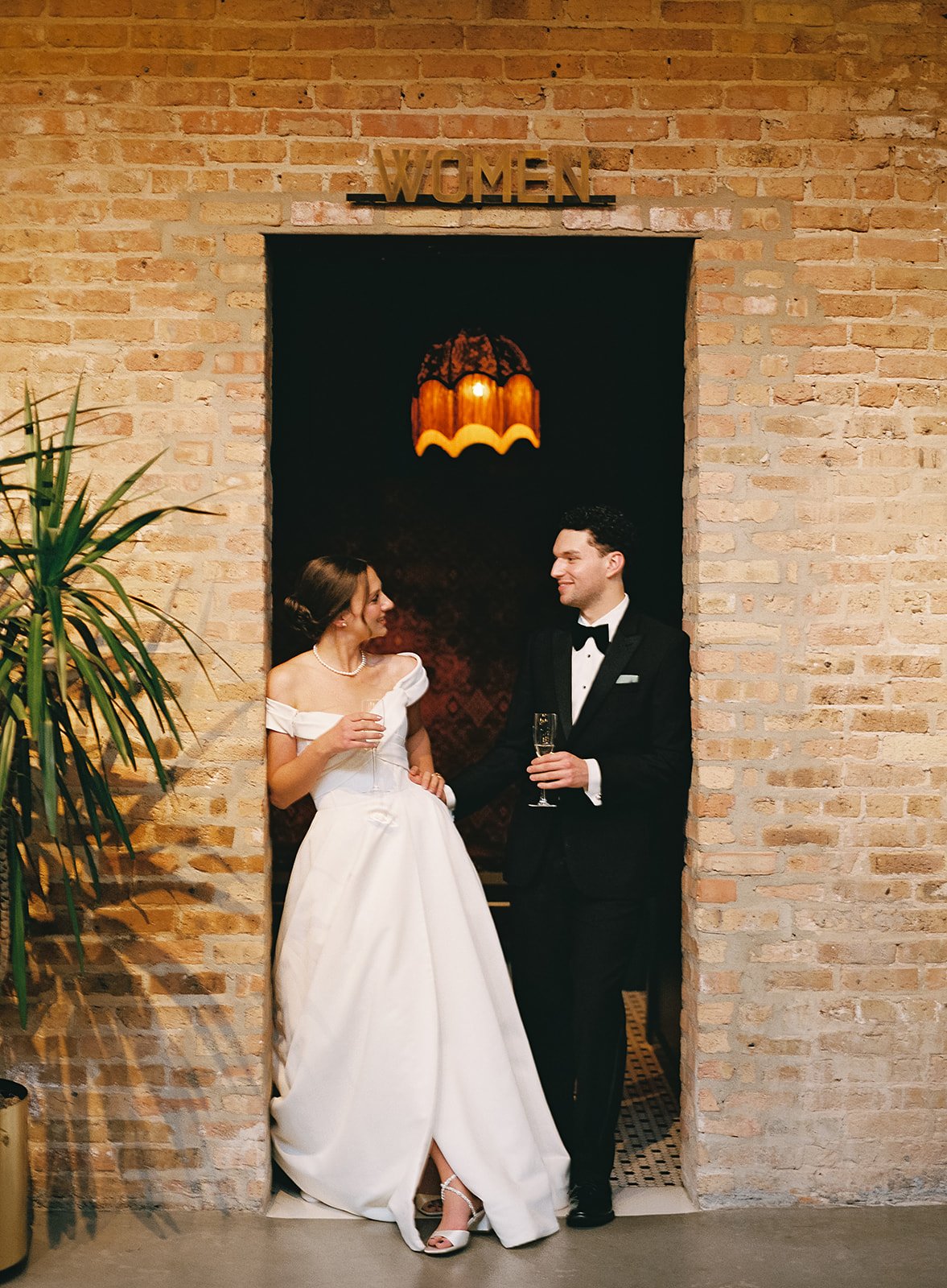 Bride and groom get married in Chicago at WildmanBT, with creative, lively wedding focused on community, family, laughter. Documentary and candid photos on flash film. Weddings by Grace is a Chicago lesbian queer luxury wedding photographer specializ