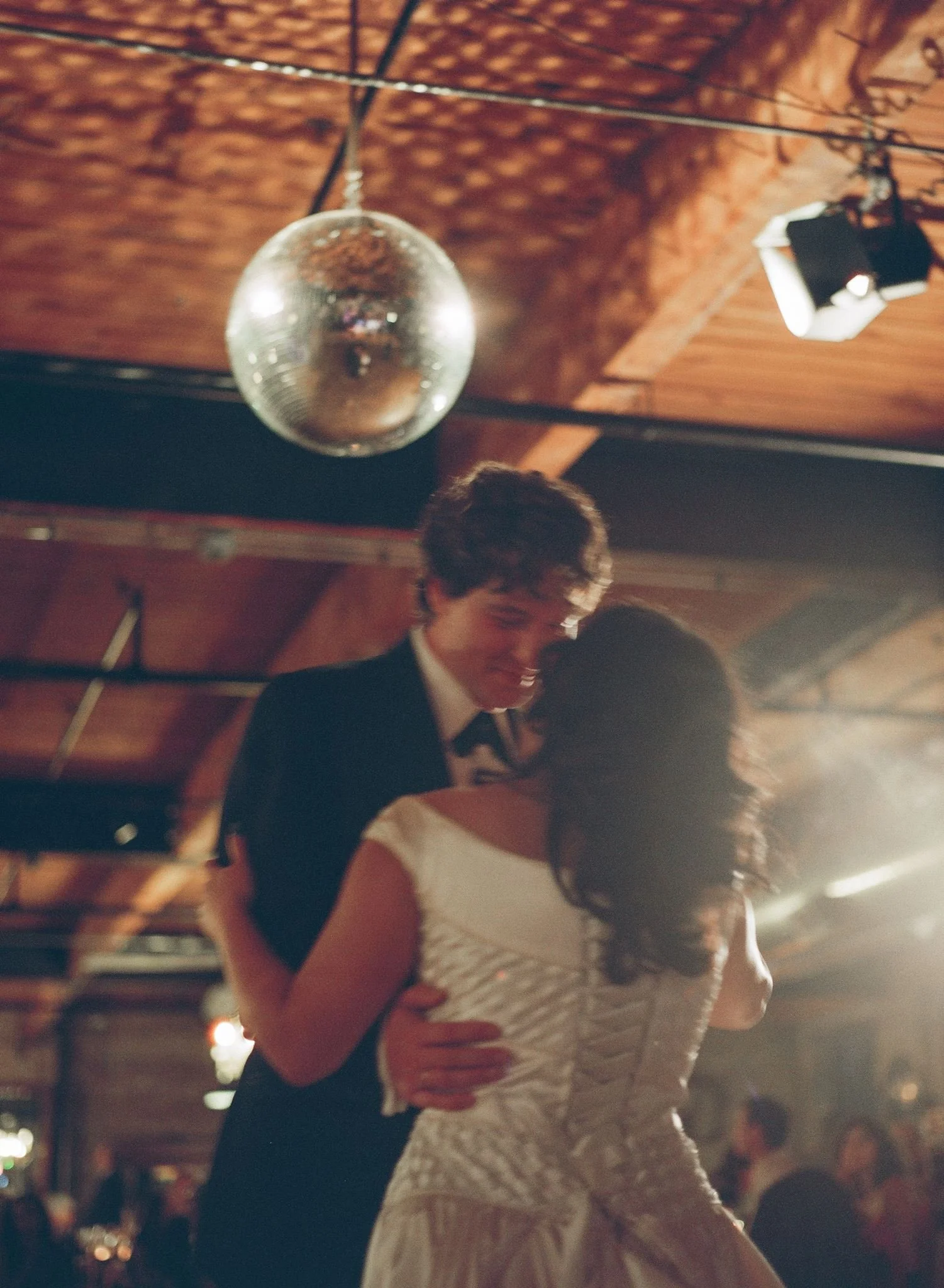 Bride and groom get married in Chicago at Salvage One, with creative, lively wedding focused on community, family, laughter. Documentary and candid photos on analog nostalgic film. Weddings by Grace is a Chicago lesbian queer luxury wedding photograp