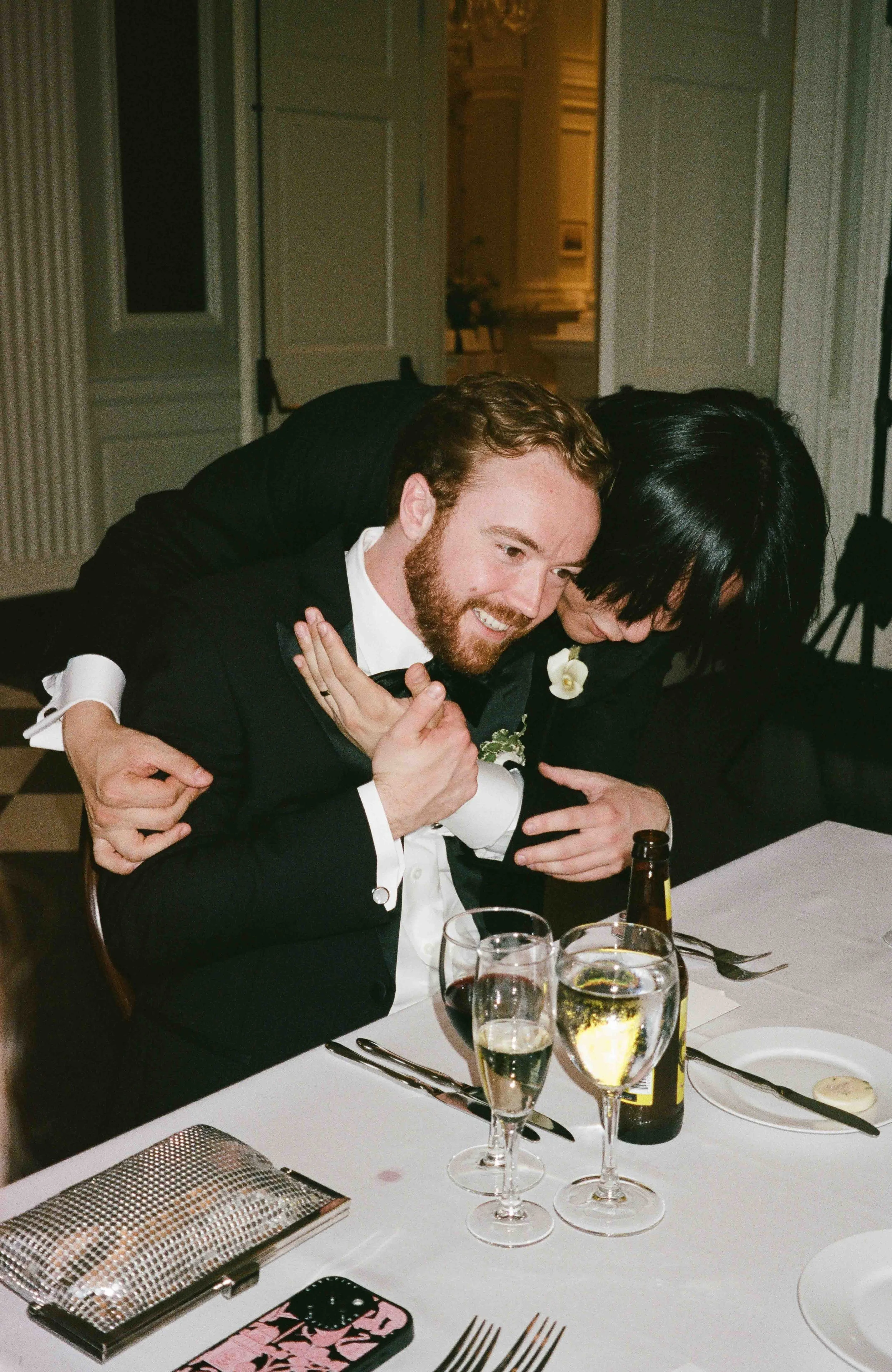 Bride and groom get married at the Chicago History Museum, with creative, lively wedding focused on community, family, laughter. Documentary and candid photos on analog nostalgic film. Weddings by Grace is a Chicago lesbian queer luxury wedding photo