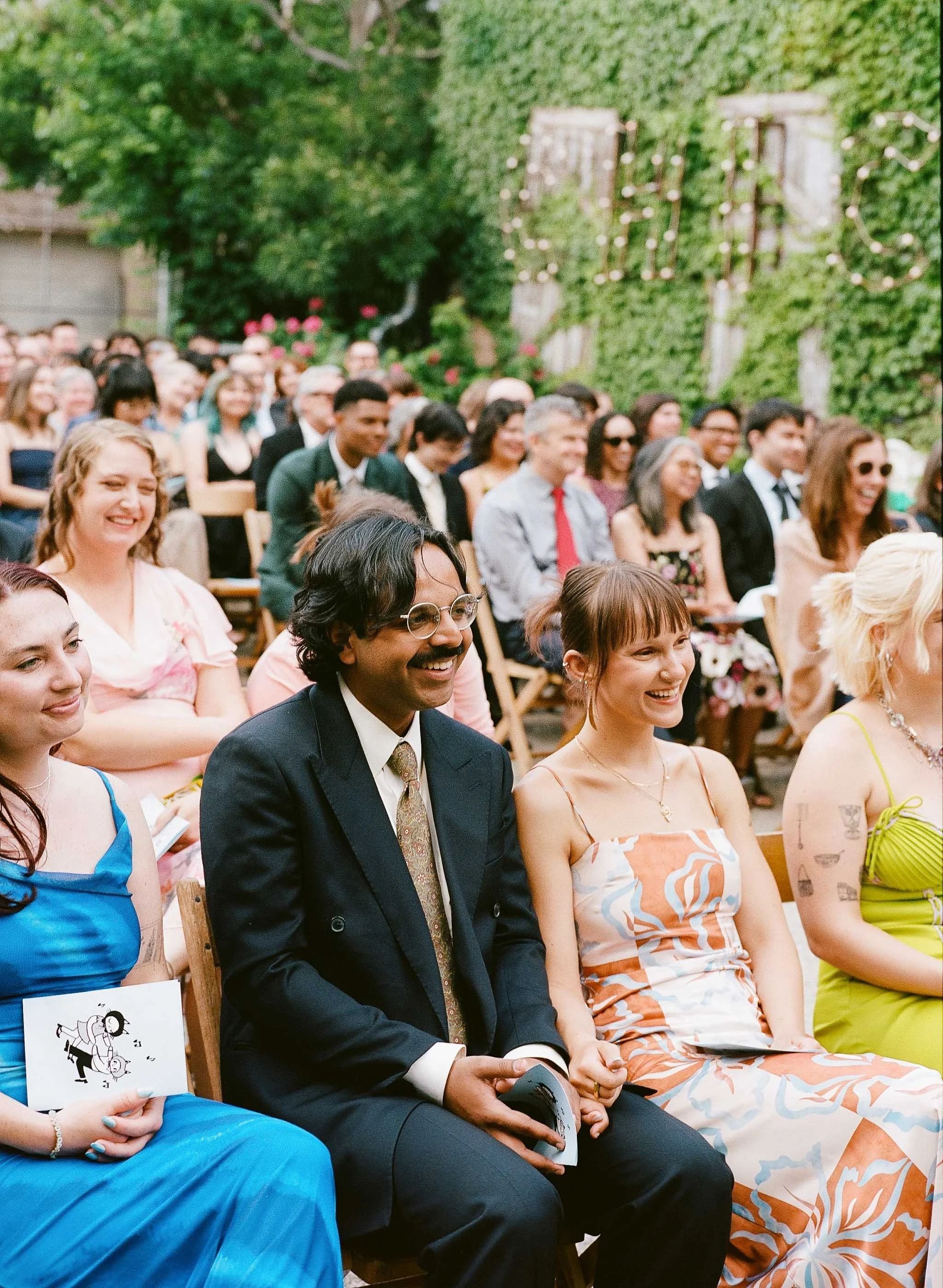 Bride and groom get married in Chicago at Salvage One, with creative, lively wedding focused on community, family, laughter. Documentary and candid photos on analog nostalgic film. Weddings by Grace is a Chicago lesbian queer luxury wedding photograp