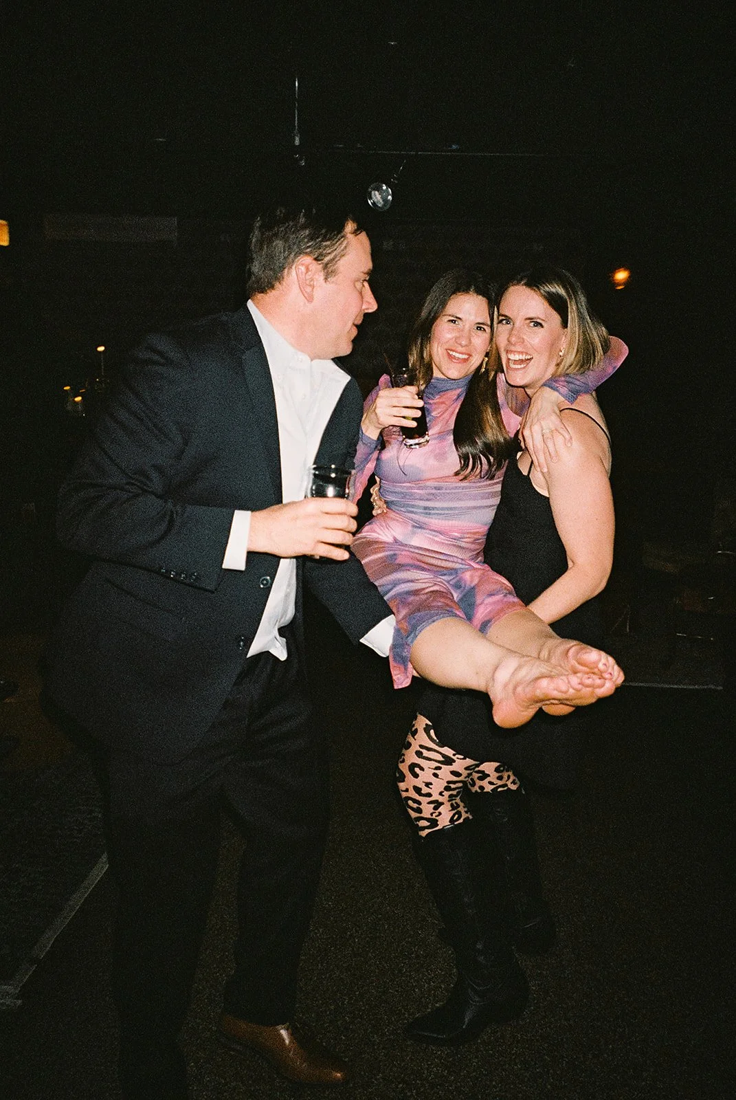 Fun flash photos of lesbian wedding at Dorothy bar. Documentary and candid photos on flash film. Weddings by Grace is a Chicago lesbian queer luxury wedding photographer specializing in portraits, candid, editorial, documentary, + artistic images wit